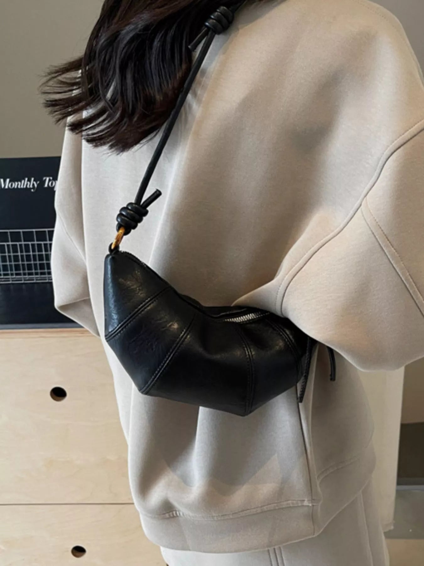 Croissant-shaped crossbody handbag by Trendsi, stylish handbag with a unique croissant design and adjustable strap.