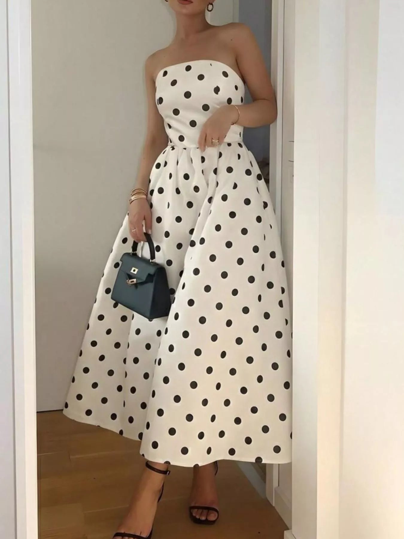 Polka dot strapless midi dress by Trendsi, featuring a fitted bodice and flared skirt, perfect for casual or semi-formal occasions.