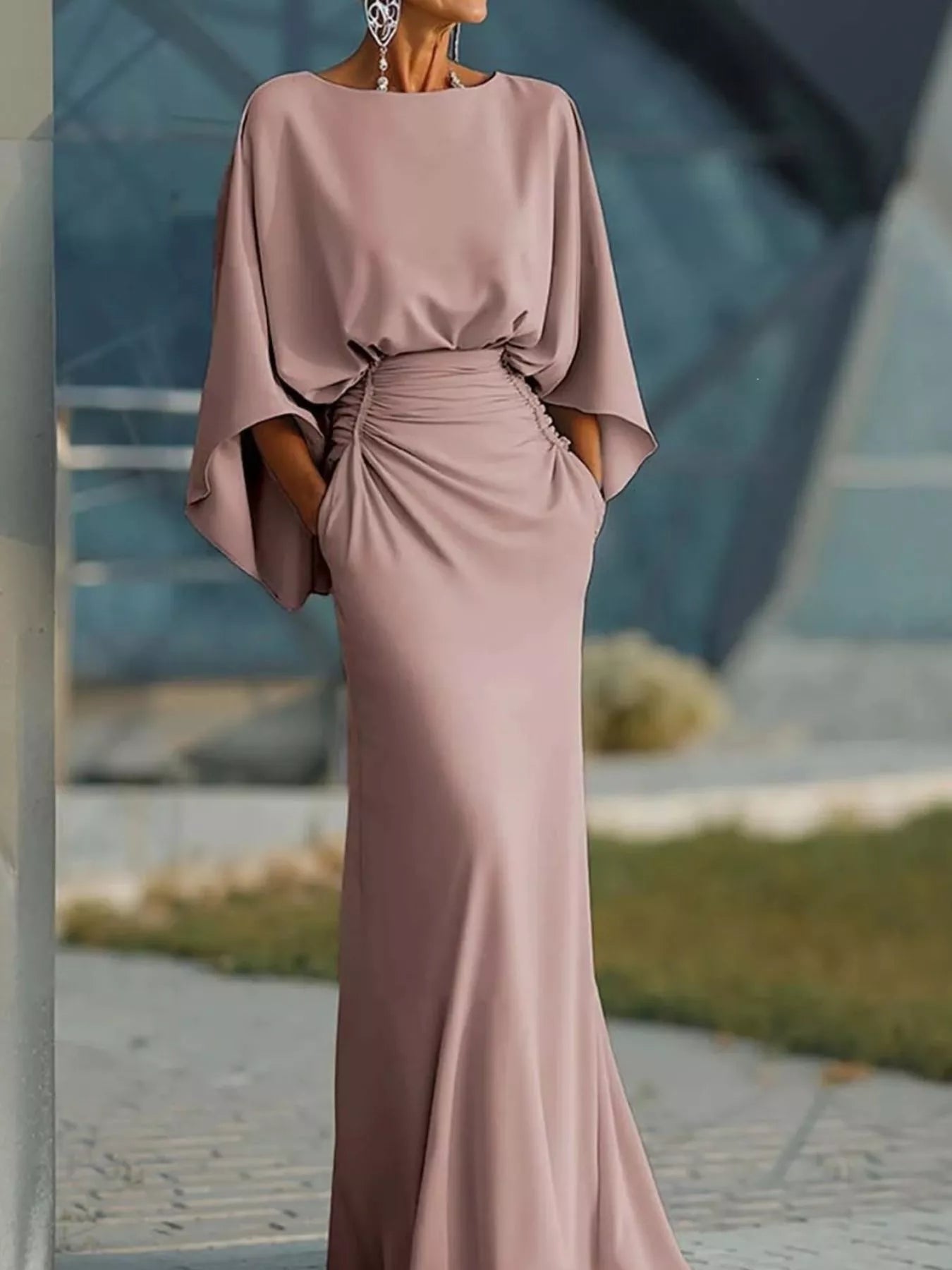 Batwing sleeve ruched evening dress with fitted waist and elegant design, ideal for formal occasions.