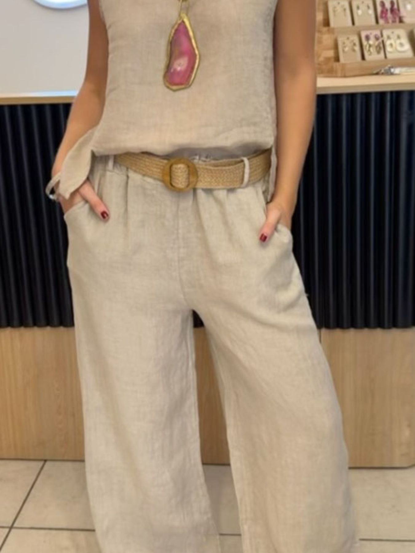 Casual round neck tank top and matching pants set from Trendsi, featuring a comfortable, relaxed fit in neutral fabric.