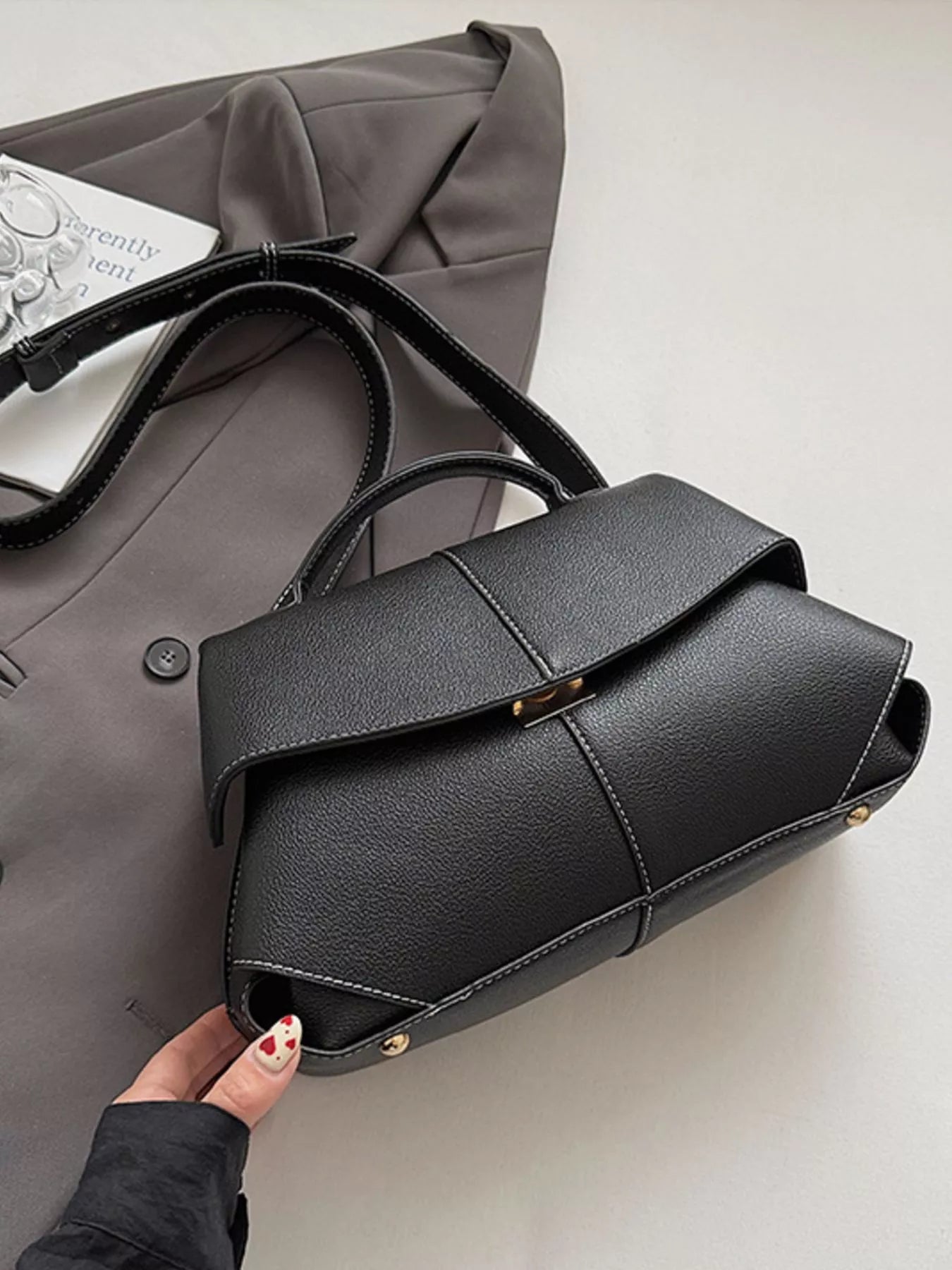 Trendsi geometric flap shoulder bag with structured design and adjustable strap, featuring a modern, geometric pattern.