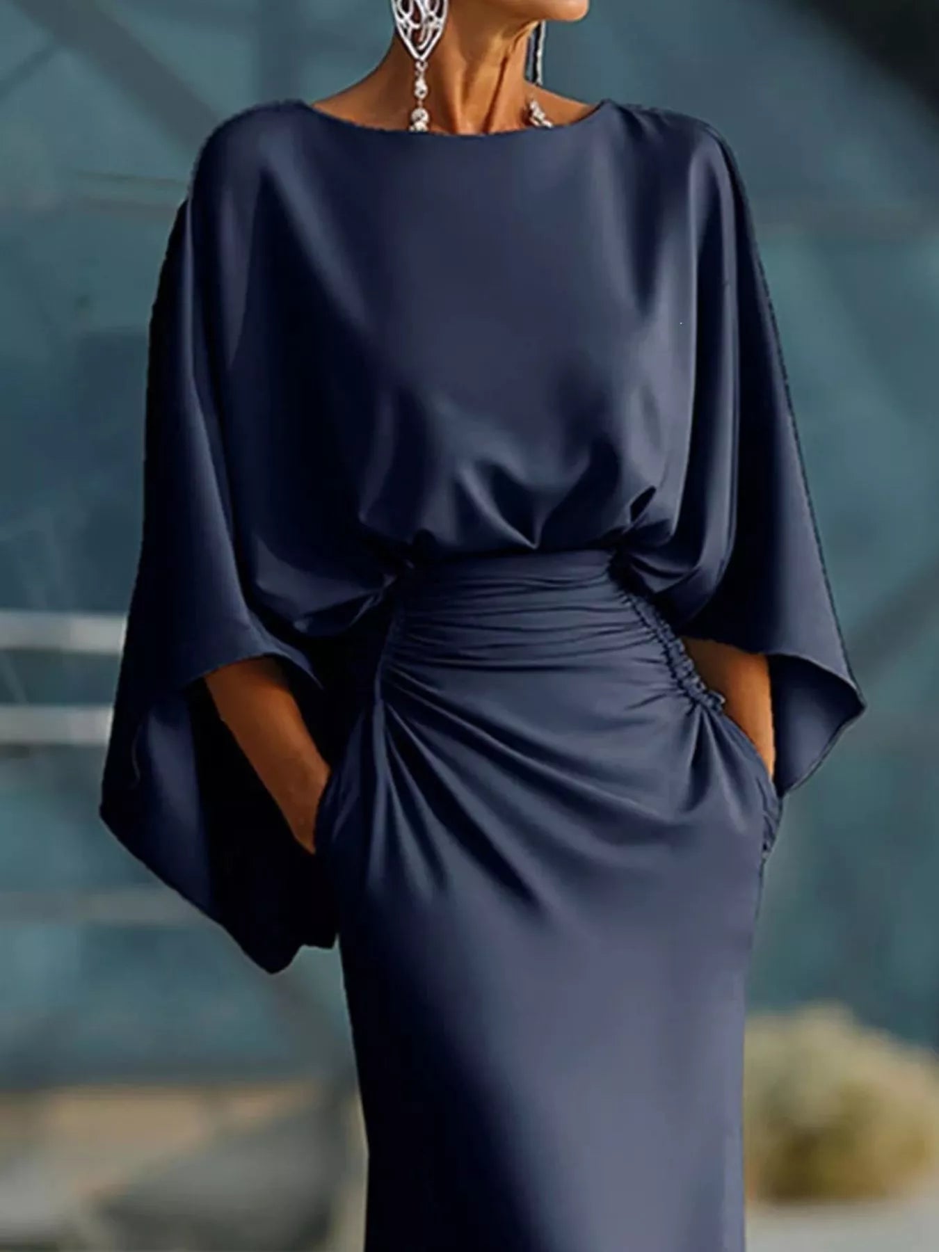 Batwing sleeve ruched evening dress by Trendsi featuring a fitted silhouette and elegant design, shown in a formal setting.