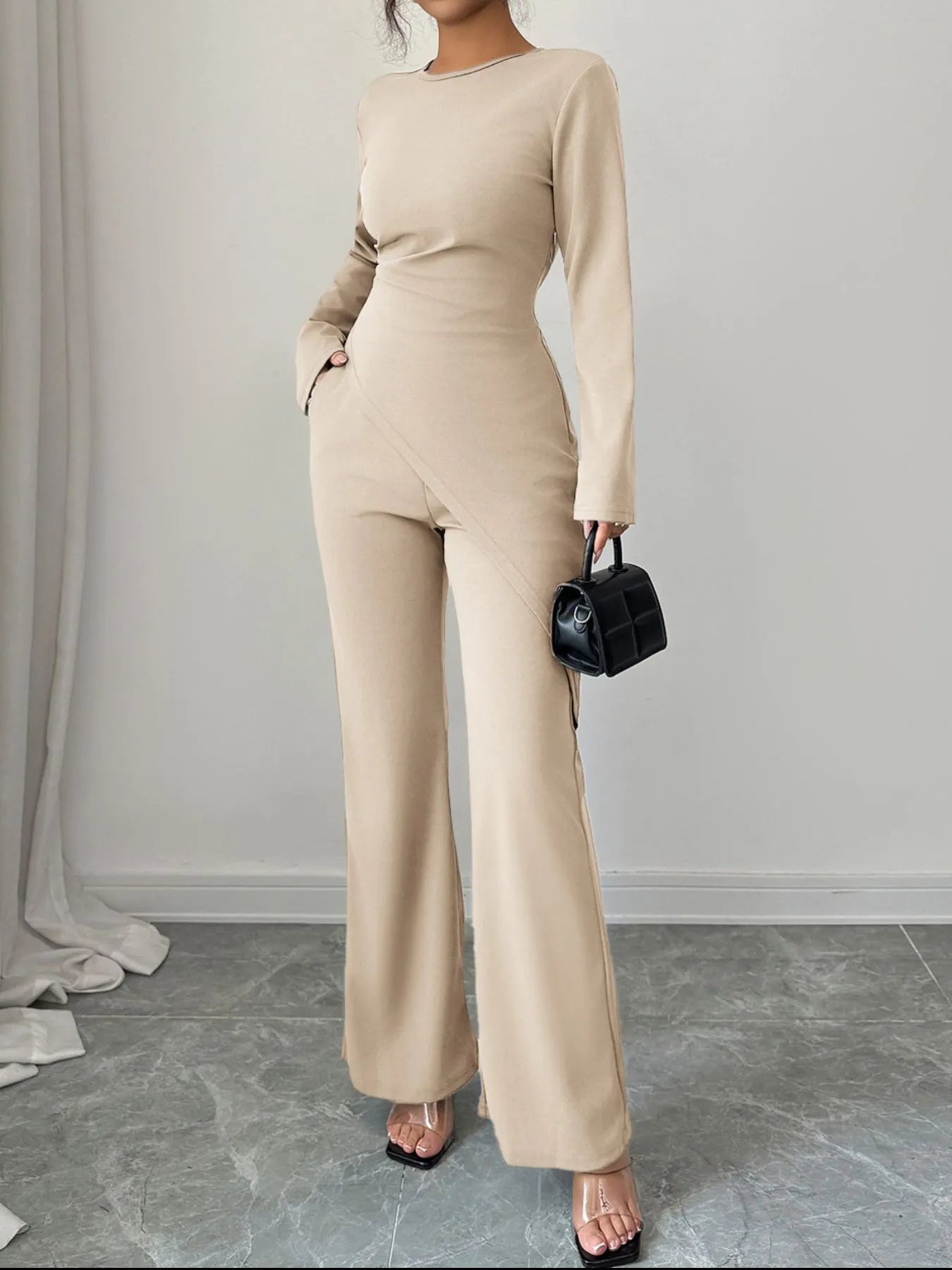 Asymmetric long sleeve top and pants set by Trendsi, featuring a stylish, modern design with a relaxed fit and coordinated look.