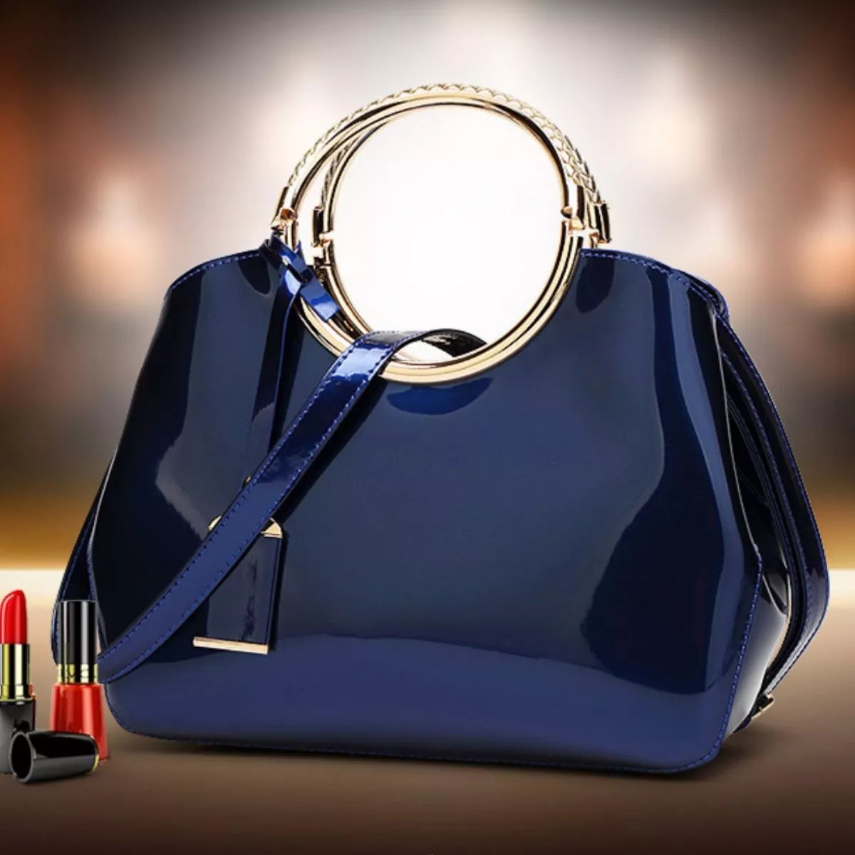 Glossy gold ring handle handbag with sleek design, featuring a shiny gold handle and structured body, perfect for stylish accessories.