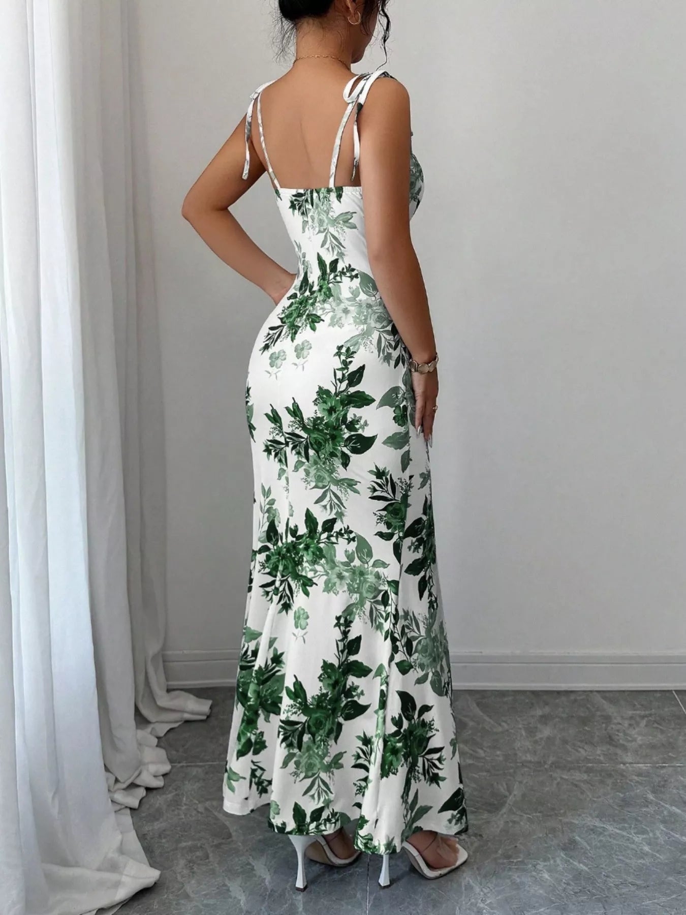 Printed tie strap slit maxi dress by Trendsi featuring a flowing silhouette, adjustable straps, and a stylish slit design.