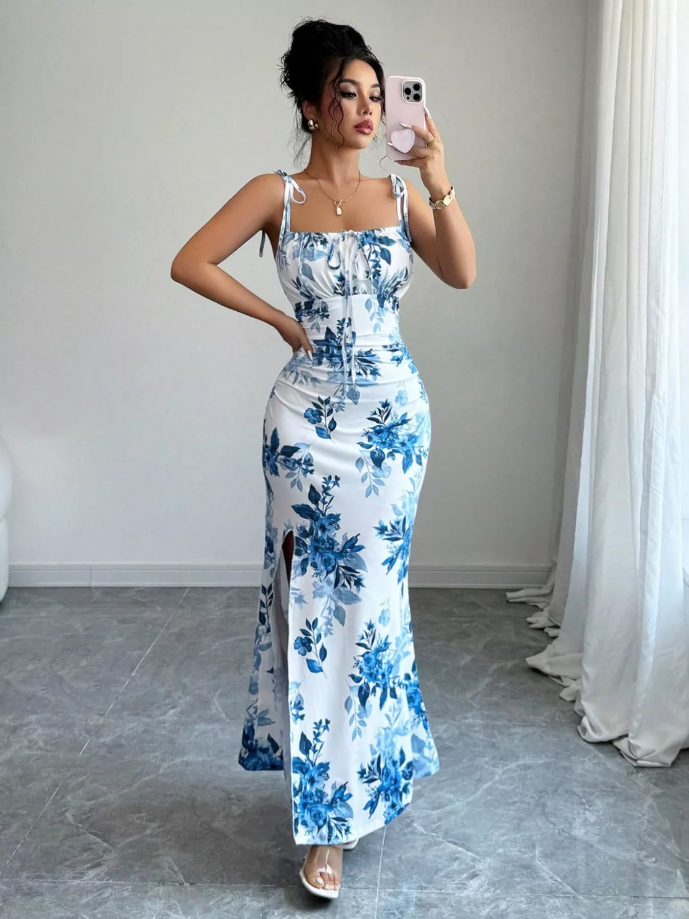 Printed tie-strap slit maxi dress by Trendsi featuring a flowy silhouette, adjustable straps, and a high slit for a stylish look.