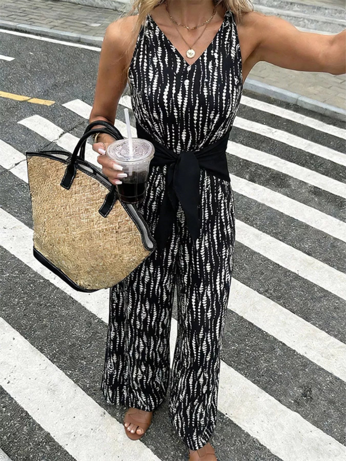 Printed wide leg jumpsuit by Trendsi featuring a relaxed fit, bold print, and stylish design perfect for casual or chic occasions.