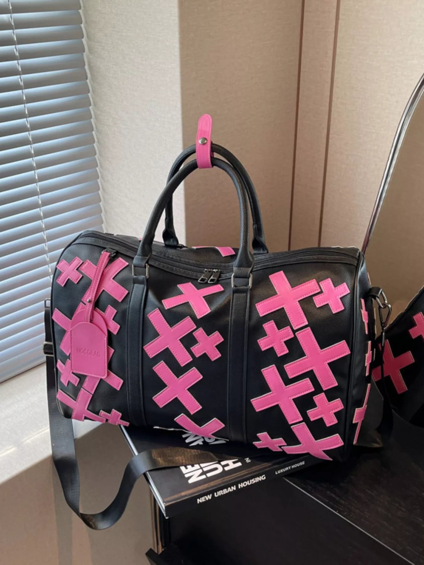 Colorful cross pattern travel duffel bag by Trendsi featuring vibrant woven fabric and sturdy handles for convenient travel storage.