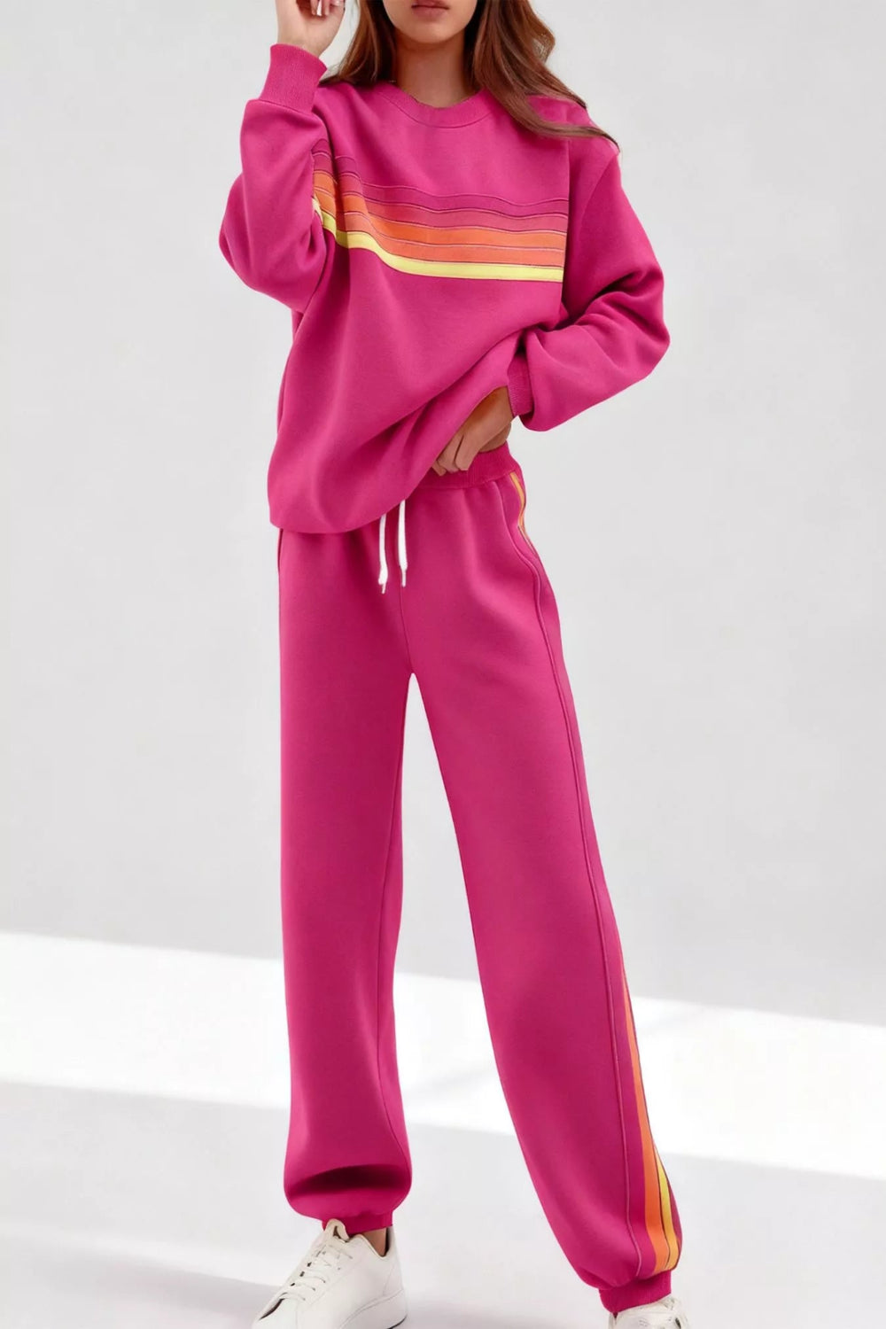 Striped round neck sweatshirt and pants set by Trendsi, featuring matching ribbed cuffs and a comfortable casual fit.