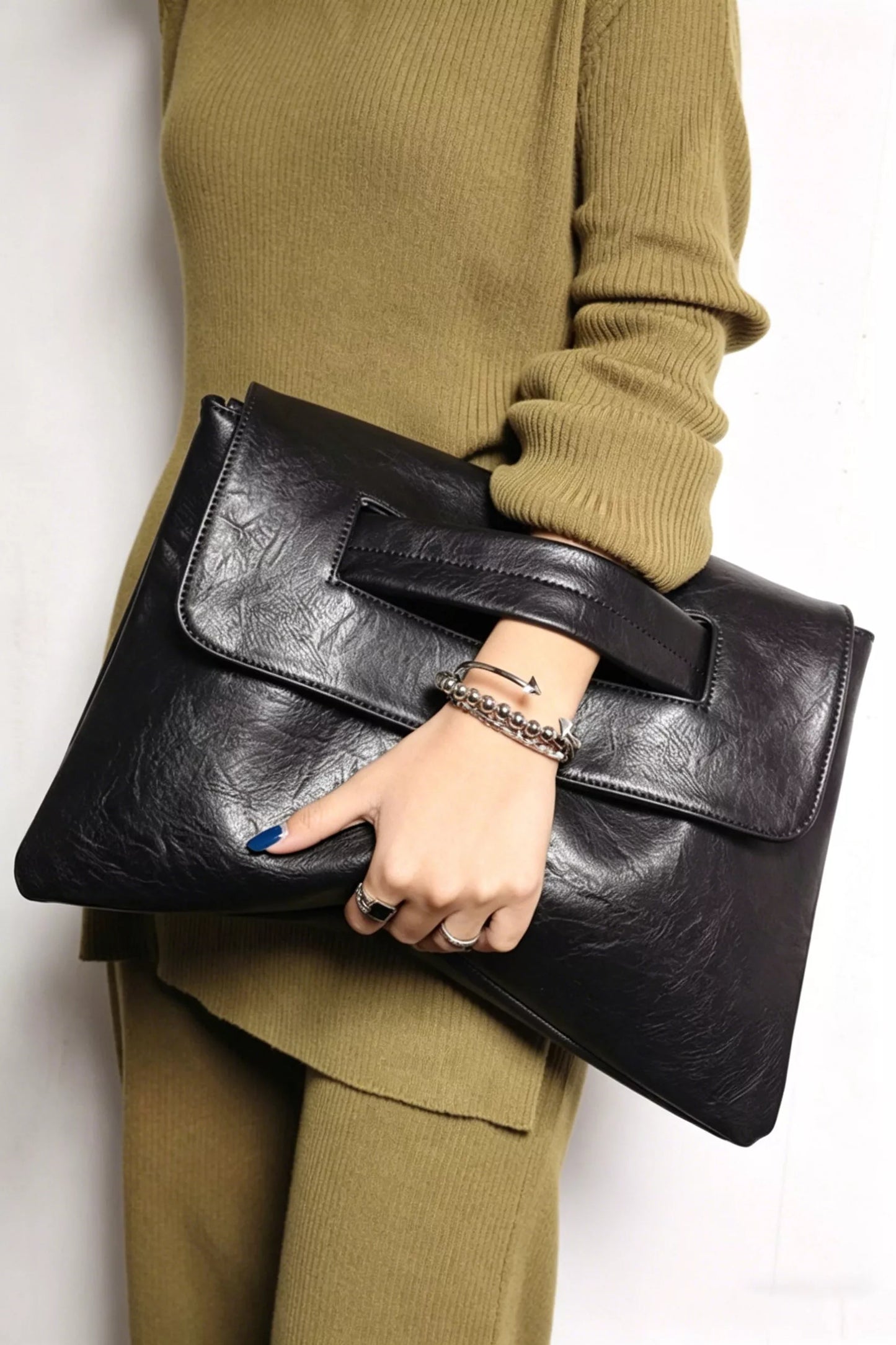 Vintage style envelope clutch handbag by Trendsi, featuring a sleek design with a fold-over flap and elegant finish.