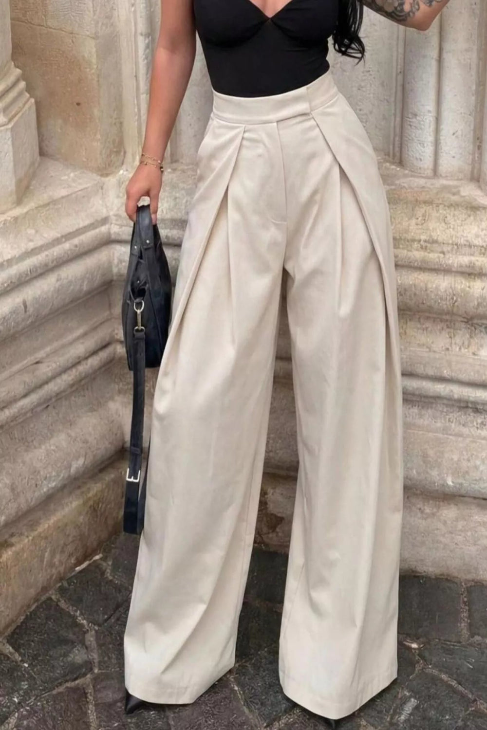 High-waisted pleated wide-leg trousers by Trendsi, featuring a stylish flowy design and tailored fit in a neutral fabric.