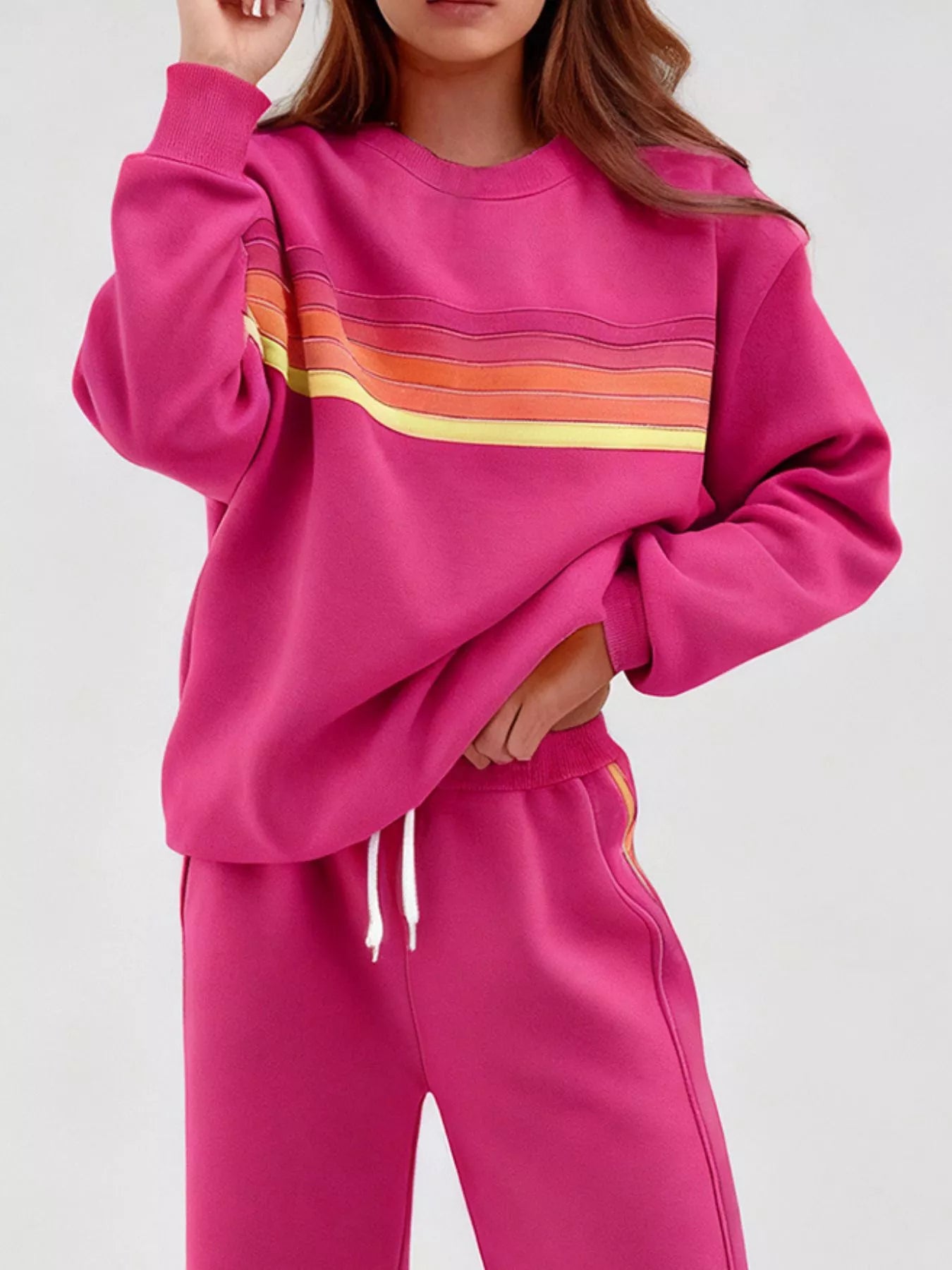Striped round neck sweatshirt and pants set by Trendsi featuring a casual, comfortable design with bold stripe patterns.