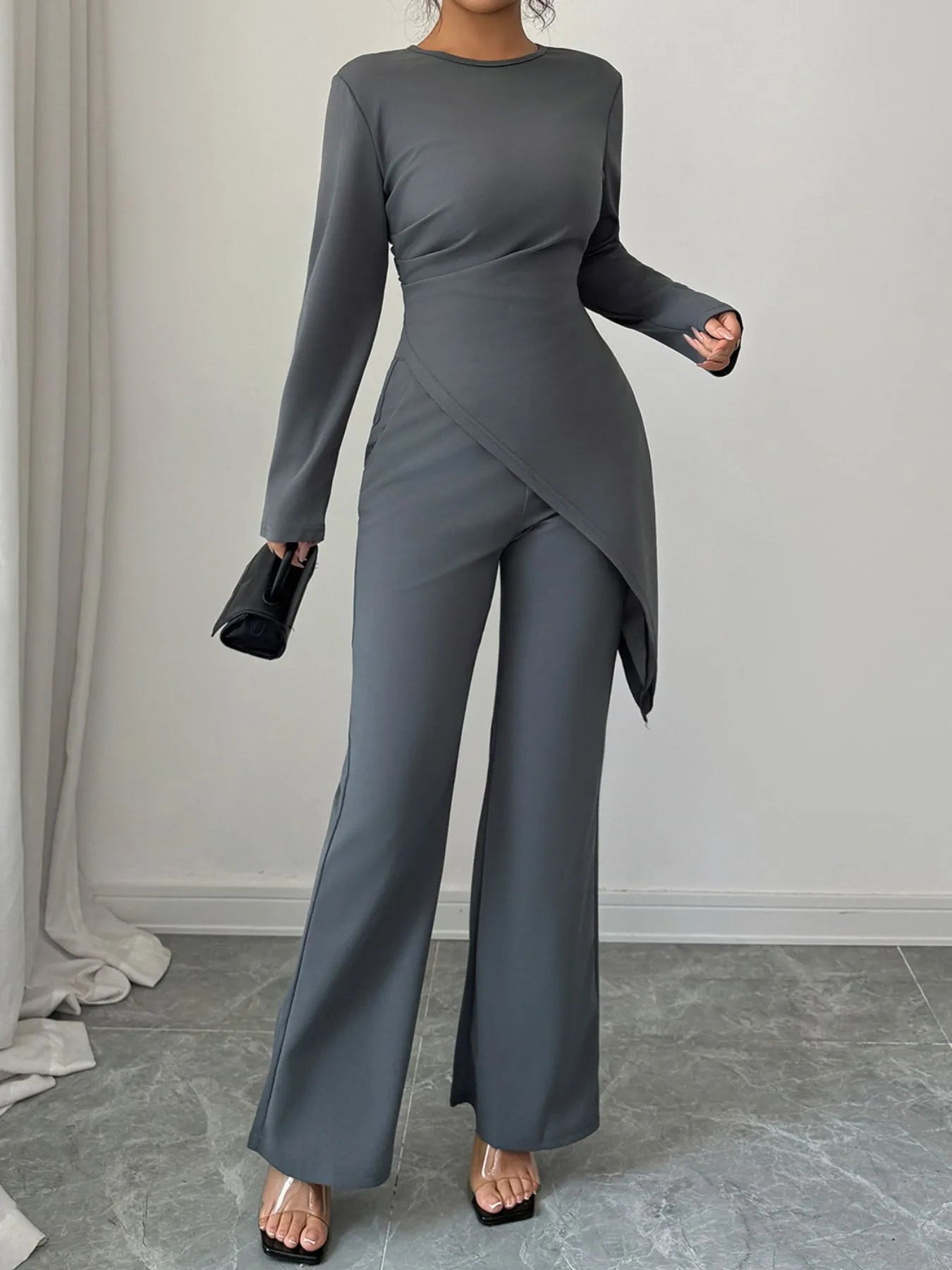 Asymmetric long sleeve top and pants set by Trendsi, featuring modern design, soft fabric, and stylish fit for casual wear.