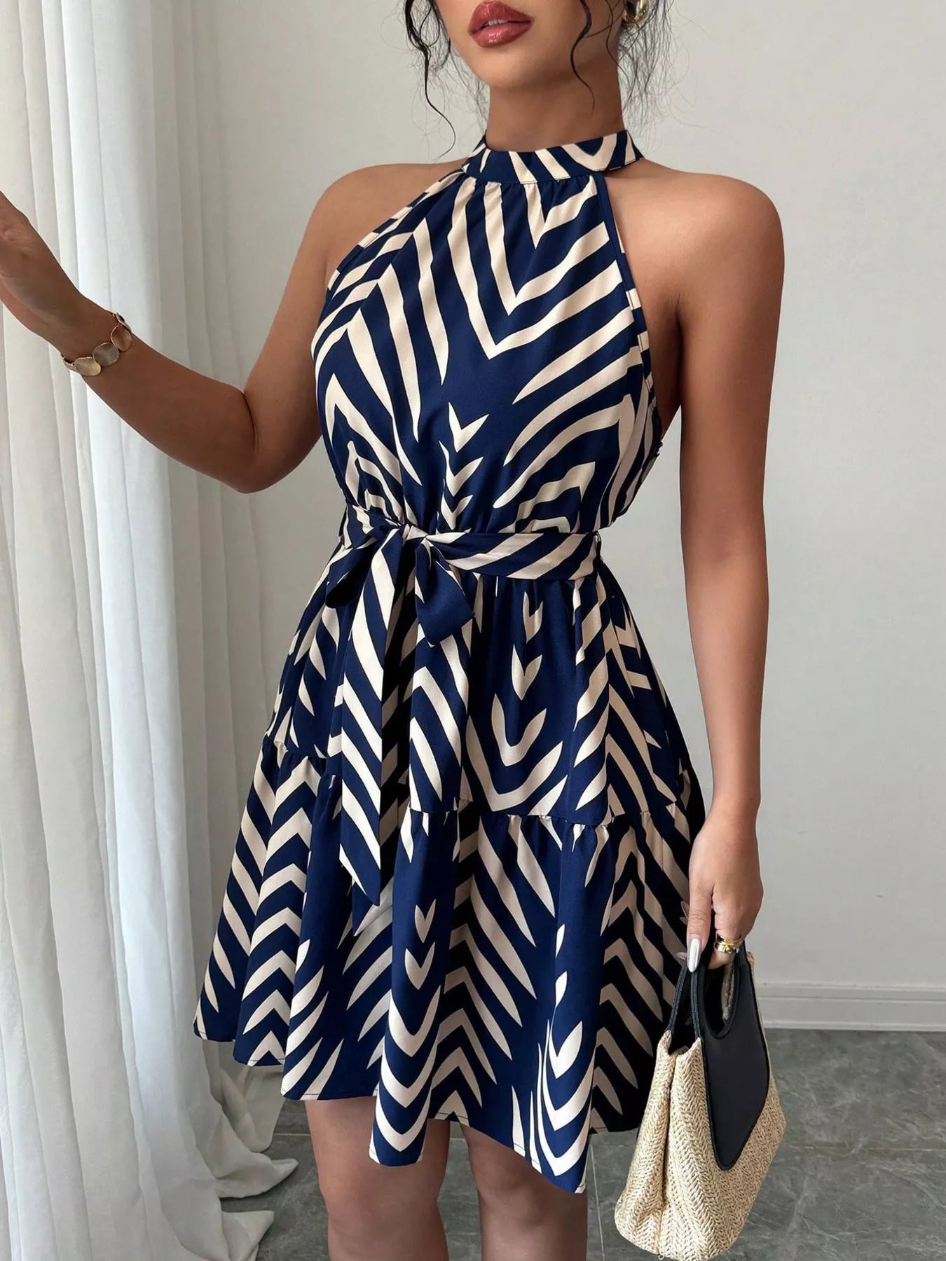 Zebra print halter neck dress with tie waist and ruffle hem, stylish trendy dress for casual or summer wear.