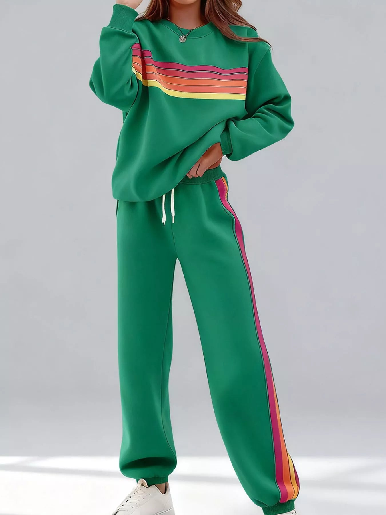 Striped round neck sweatshirt and pants set by Trendsi, featuring a casual, comfortable design with bold stripe patterns.