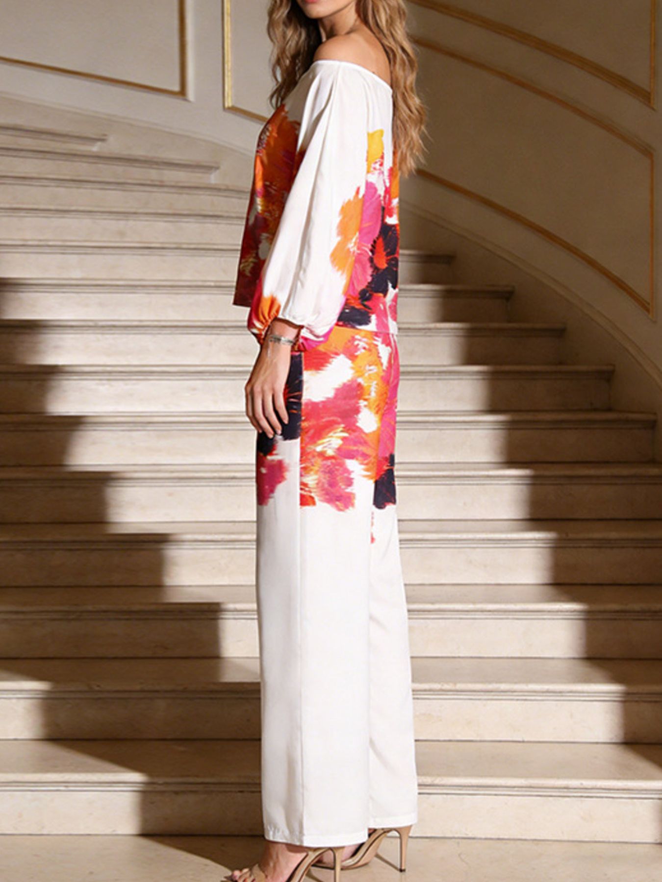 Floral print off-shoulder top and matching pants set by Trendsi, featuring a vibrant, stylish design perfect for casual wear.
