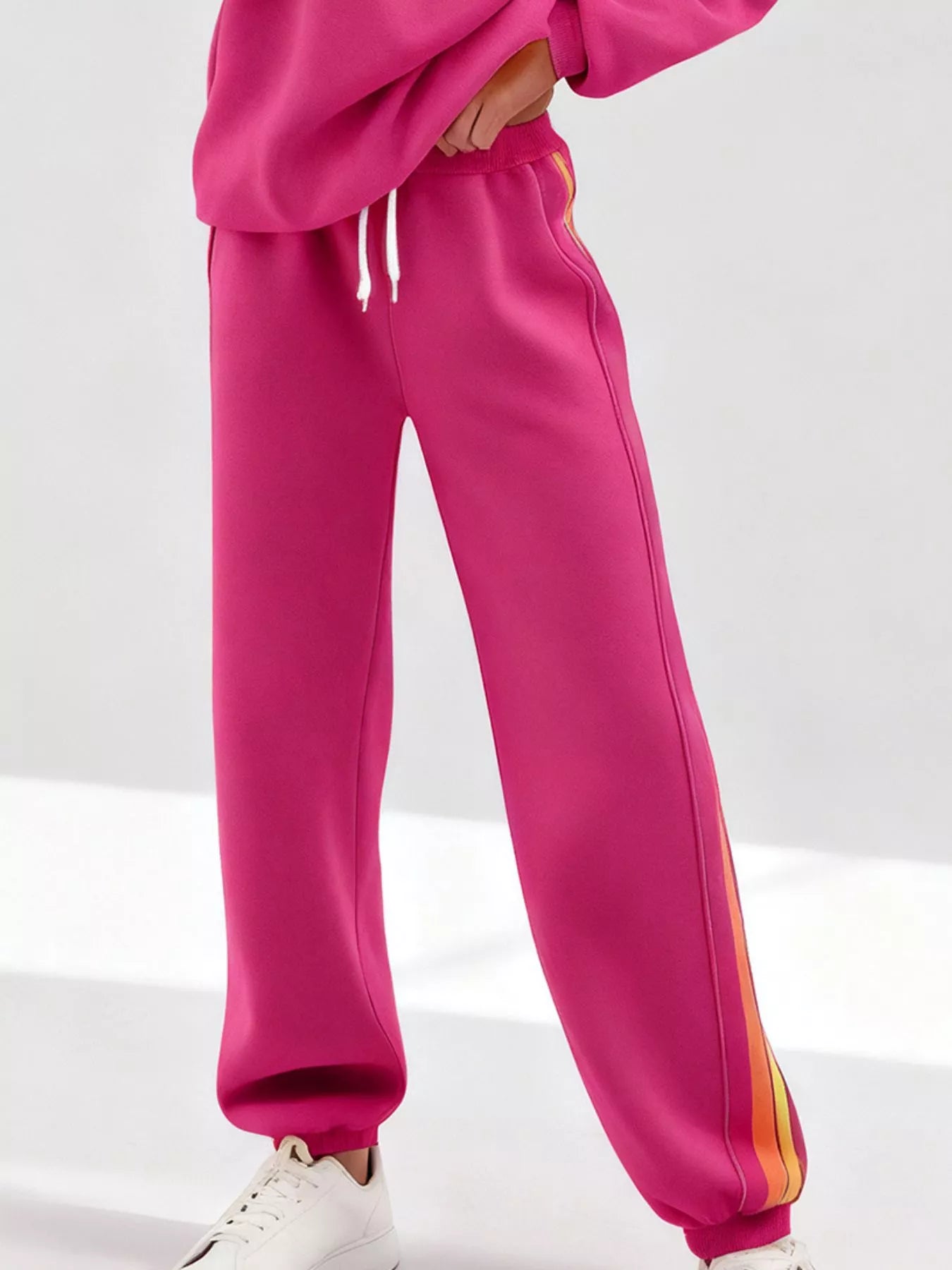 Striped round neck sweatshirt and pants set by Trendsi, featuring a cozy, casual design with bold stripe pattern and comfortable fit.