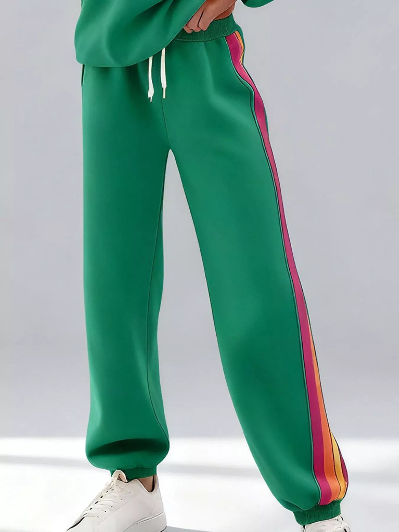 Striped round neck sweatshirt and pants set by Trendsi featuring a casual, comfortable design with bold stripe patterns.