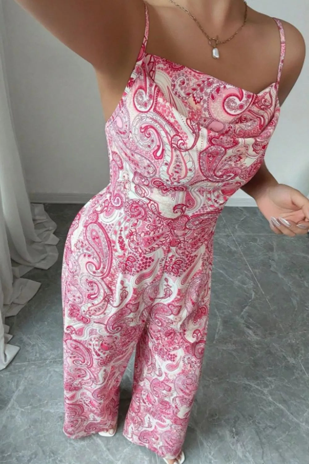 Pink Paisley wide-leg jumpsuit by Trendsi featuring a relaxed fit, sleeveless design, and bold paisley pattern.