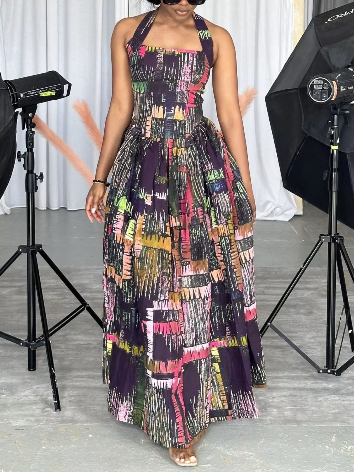 Abstract print halter neck maxi dress by Trendsi, flowing dress with vibrant pattern and elegant design, shown on a model.