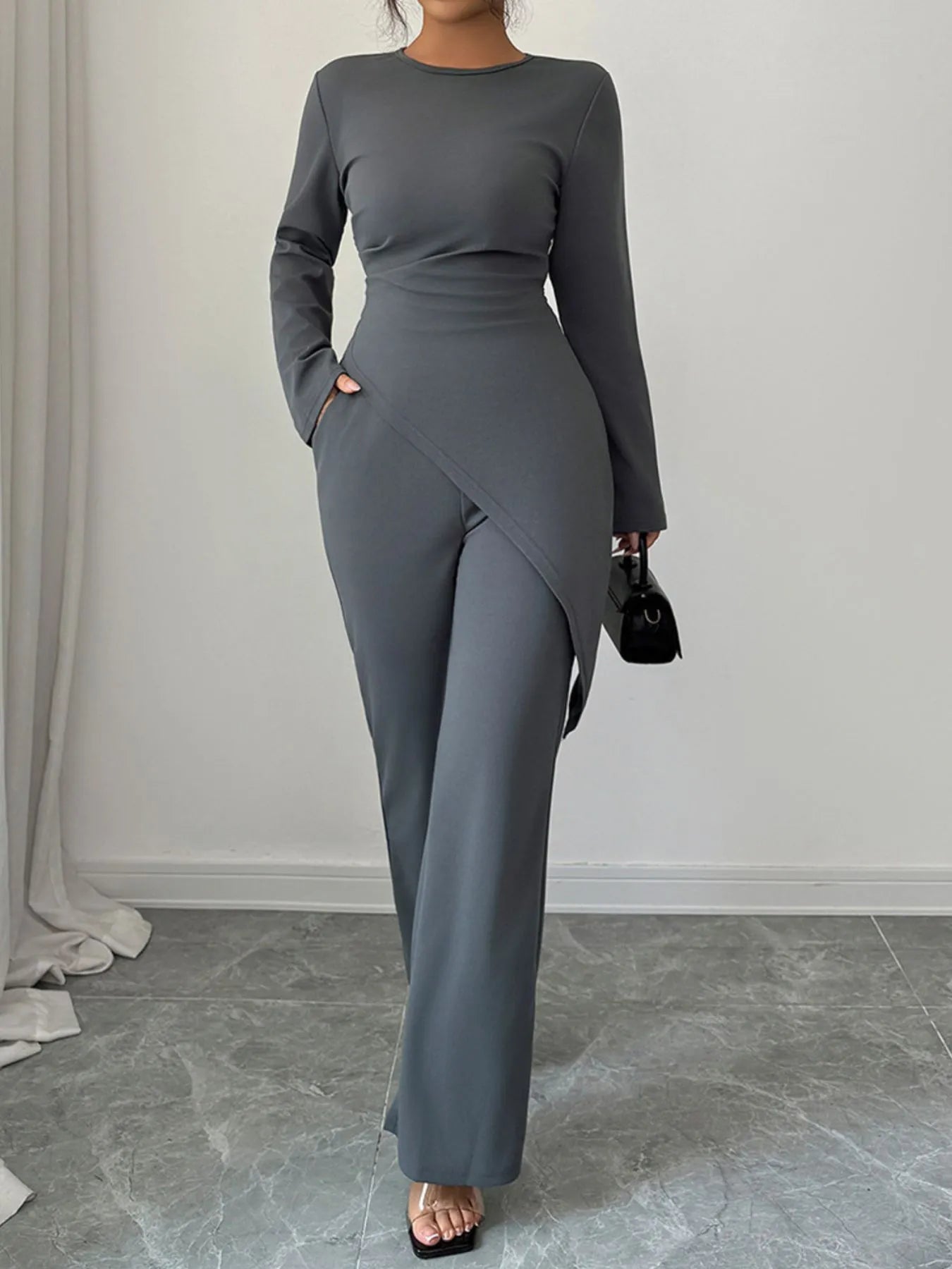 Asymmetric long sleeve top and matching pants set by Trendsi, stylish and modern casual wear, shown in black fabric.