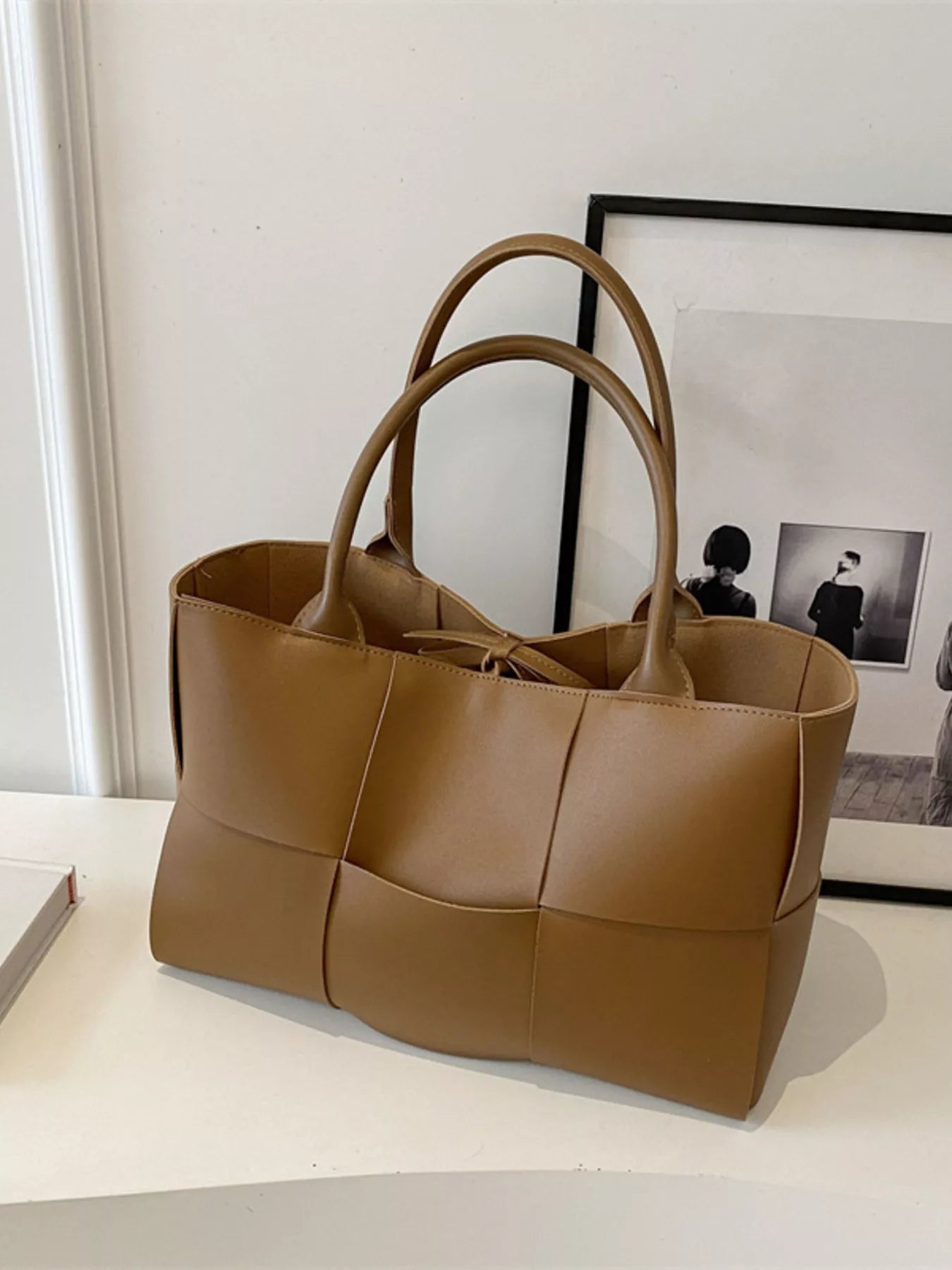 Woven leather tote handbag with sturdy handles and natural texture, stylish Trendsi handbag for everyday use