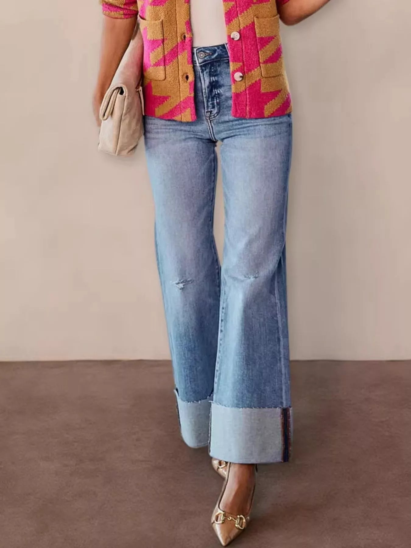 Distressed high-waisted flare jeans in denim with frayed details, styled by Trendsi, shown on a model.