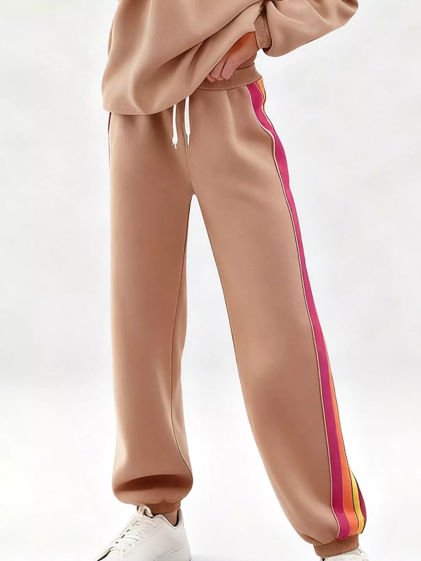 Striped round neck sweatshirt and matching pants set by Trendsi, casual loungewear with colorful vertical stripes.