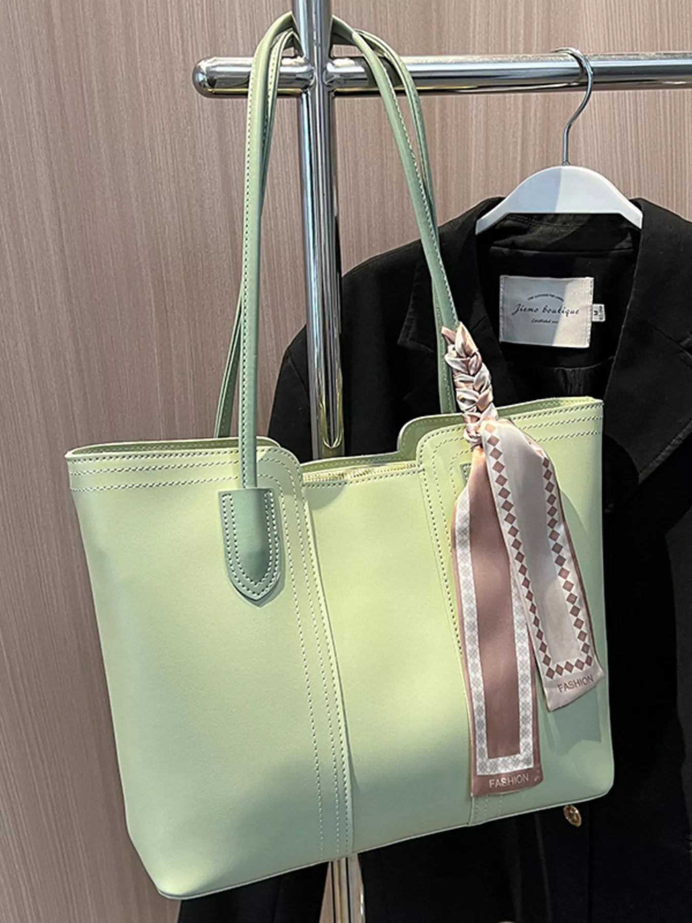 Casual tote shoulder bag from Trendsi with spacious design, sturdy handles, and versatile style in neutral color.
