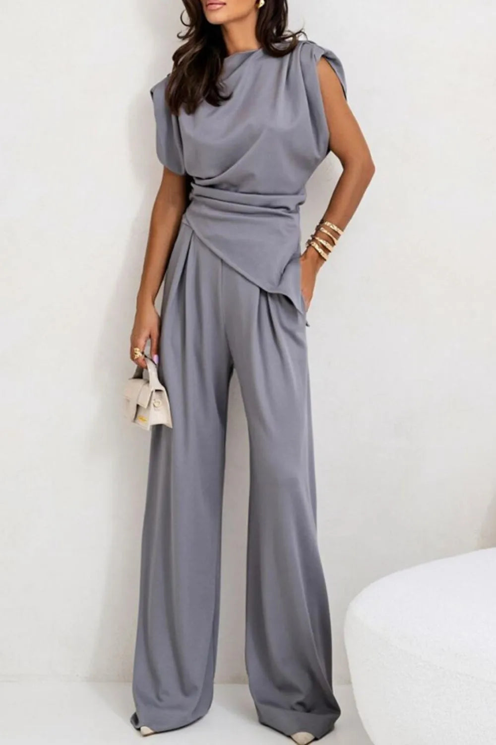 Draped sleeveless asymmetric top and matching pants set by Trendsi, stylish and modern outfit for fashionable wear.