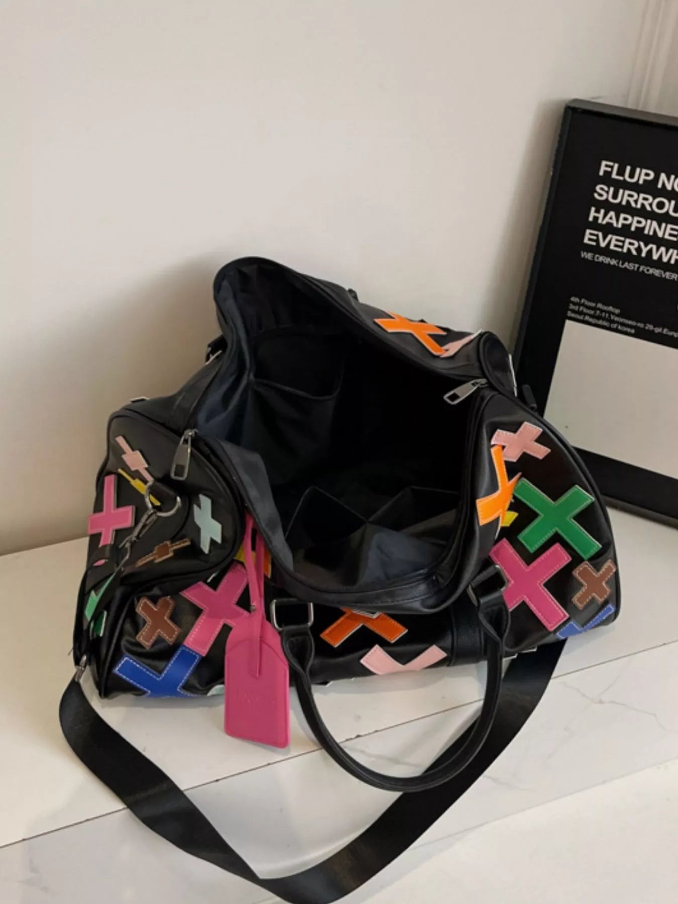 Colorful cross pattern travel duffel bag by Trendsi, featuring a spacious design and vibrant woven fabric for versatile use.