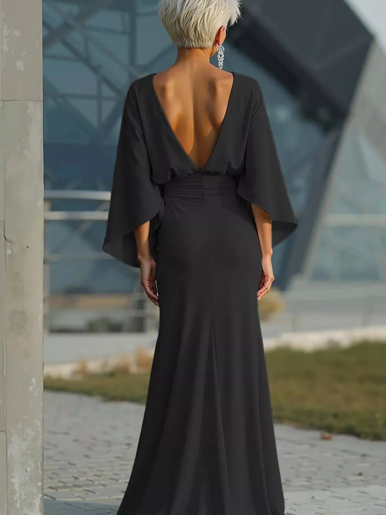 Batwing sleeve ruched evening dress by Trendsi, featuring elegant draped fabric and a fitted silhouette for formal occasions.