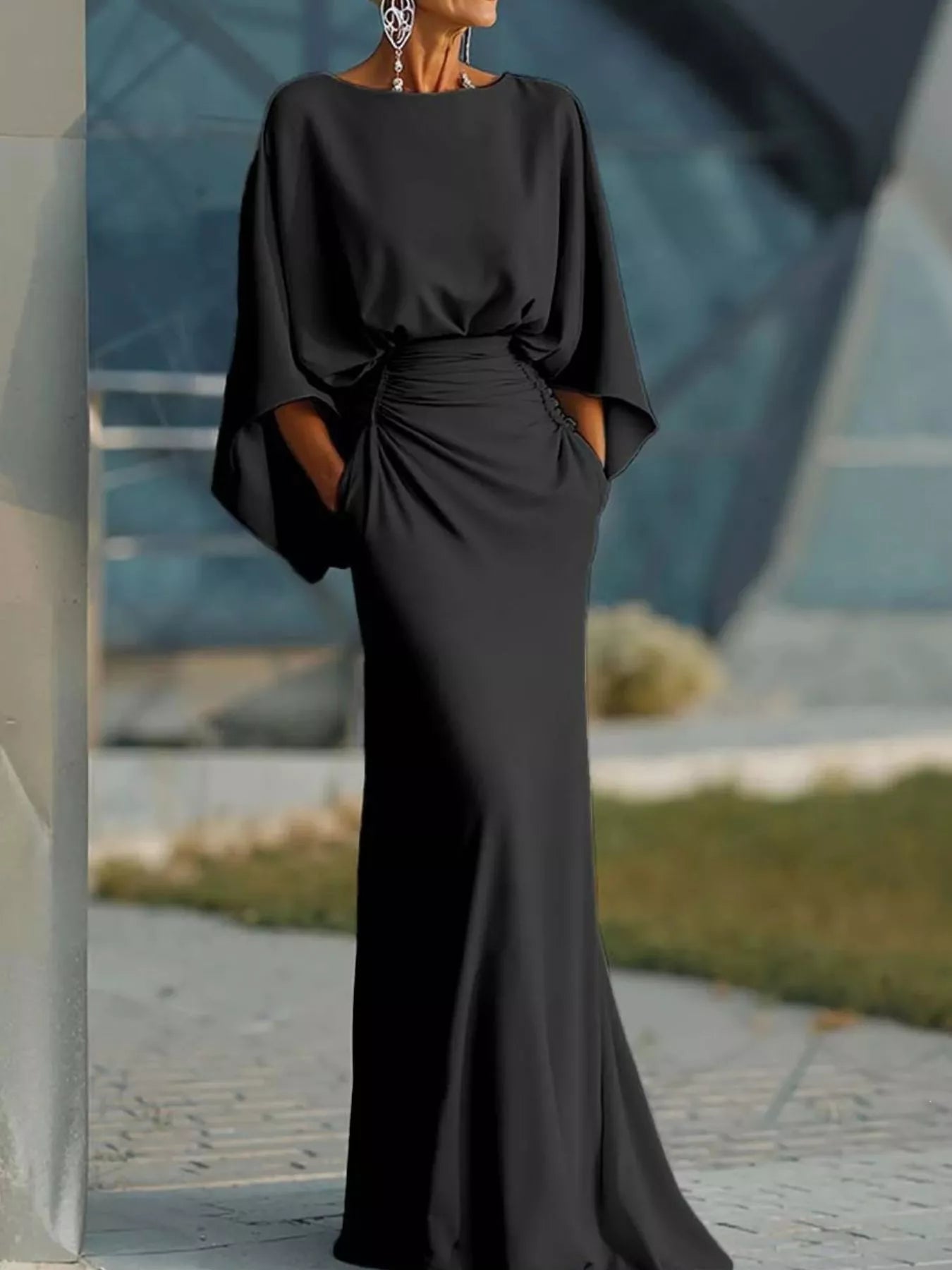 Elegant black batwing sleeve ruched evening dress by Trendsi, featuring flowy sleeves and fitted ruched bodice for formal occasions.