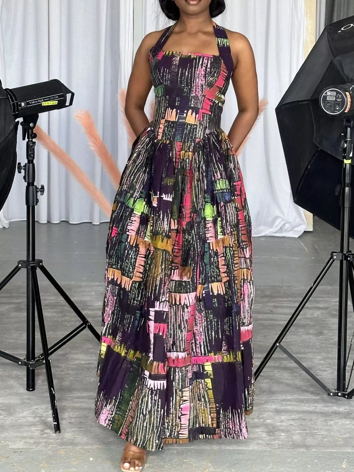 Abstract print halter neck maxi dress by Trendsi featuring a flowing silhouette and vibrant pattern, perfect for summer occasions.