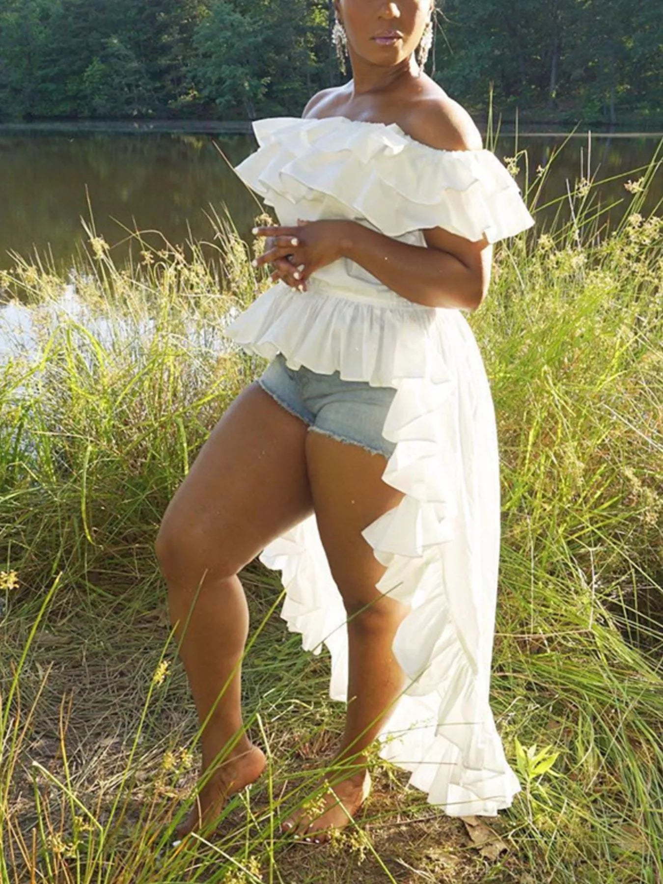Ruffle off-shoulder high-low blouse from Trendsi featuring lightweight fabric and feminine ruffle details on a stylish top.