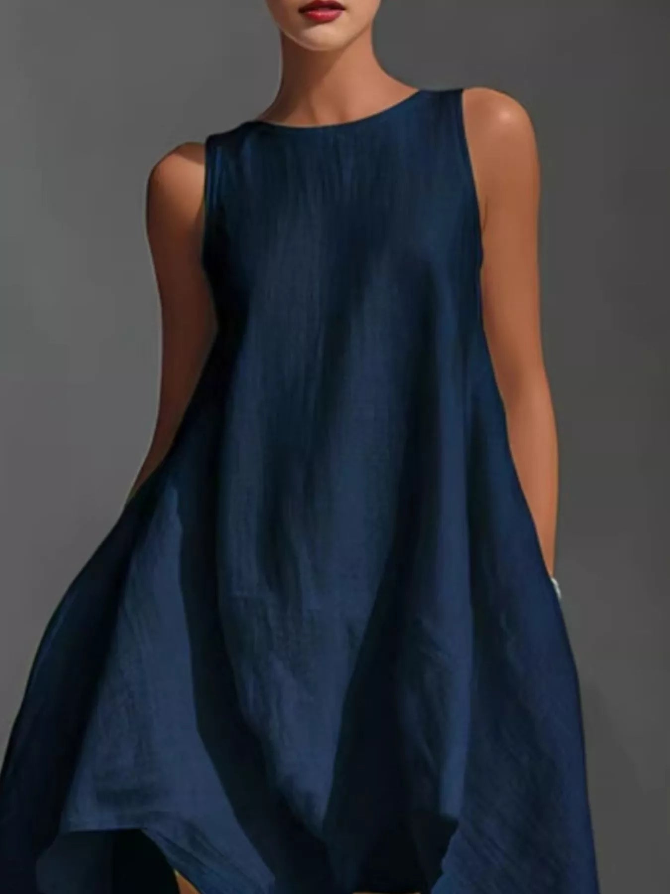 Sleeveless high-low round neck dress from Trendsi, featuring a flowing silhouette and stylish design perfect for casual or semi-formal wear.