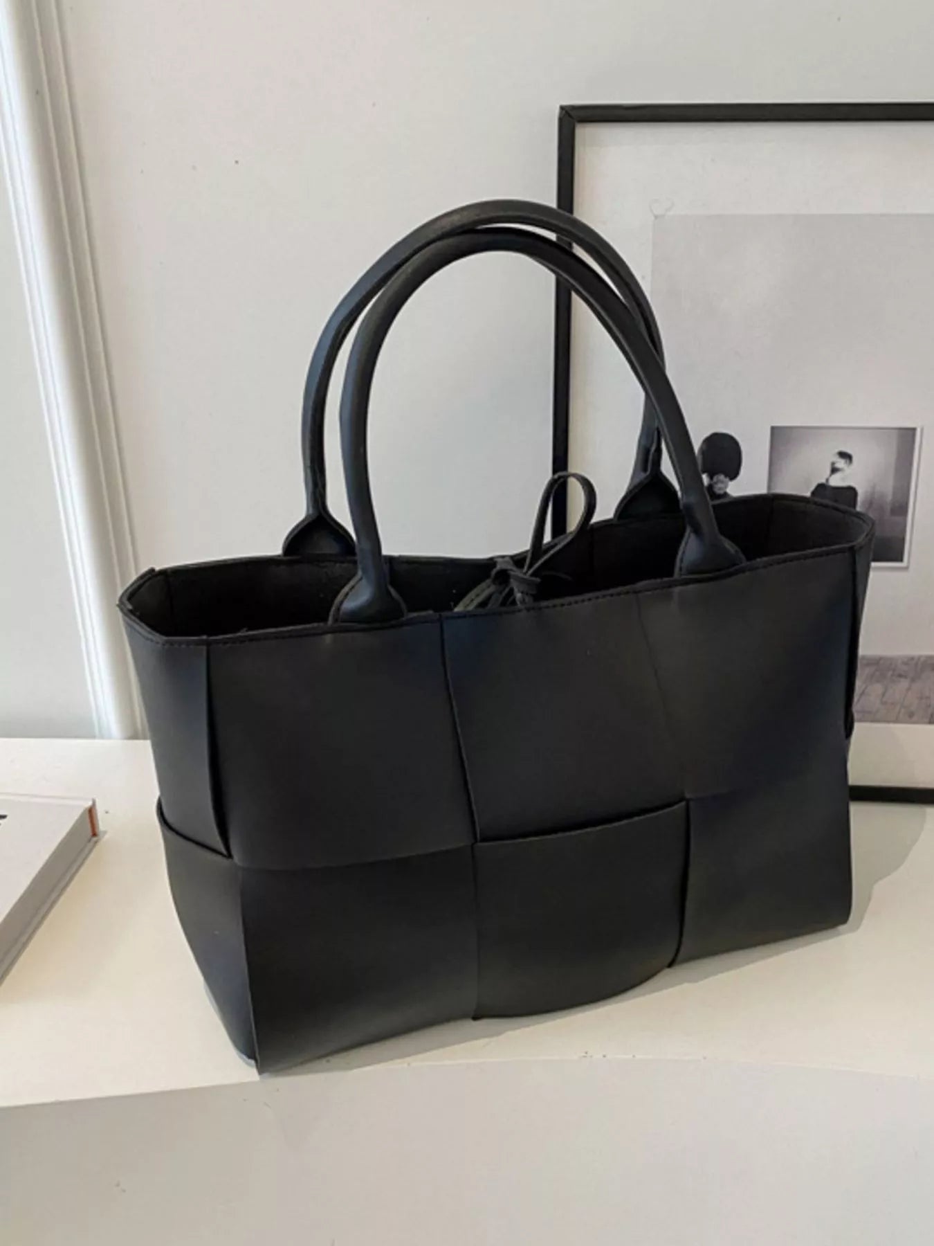 Woven leather tote bag by Trendsi, stylish handbag with natural woven design and durable leather handles.