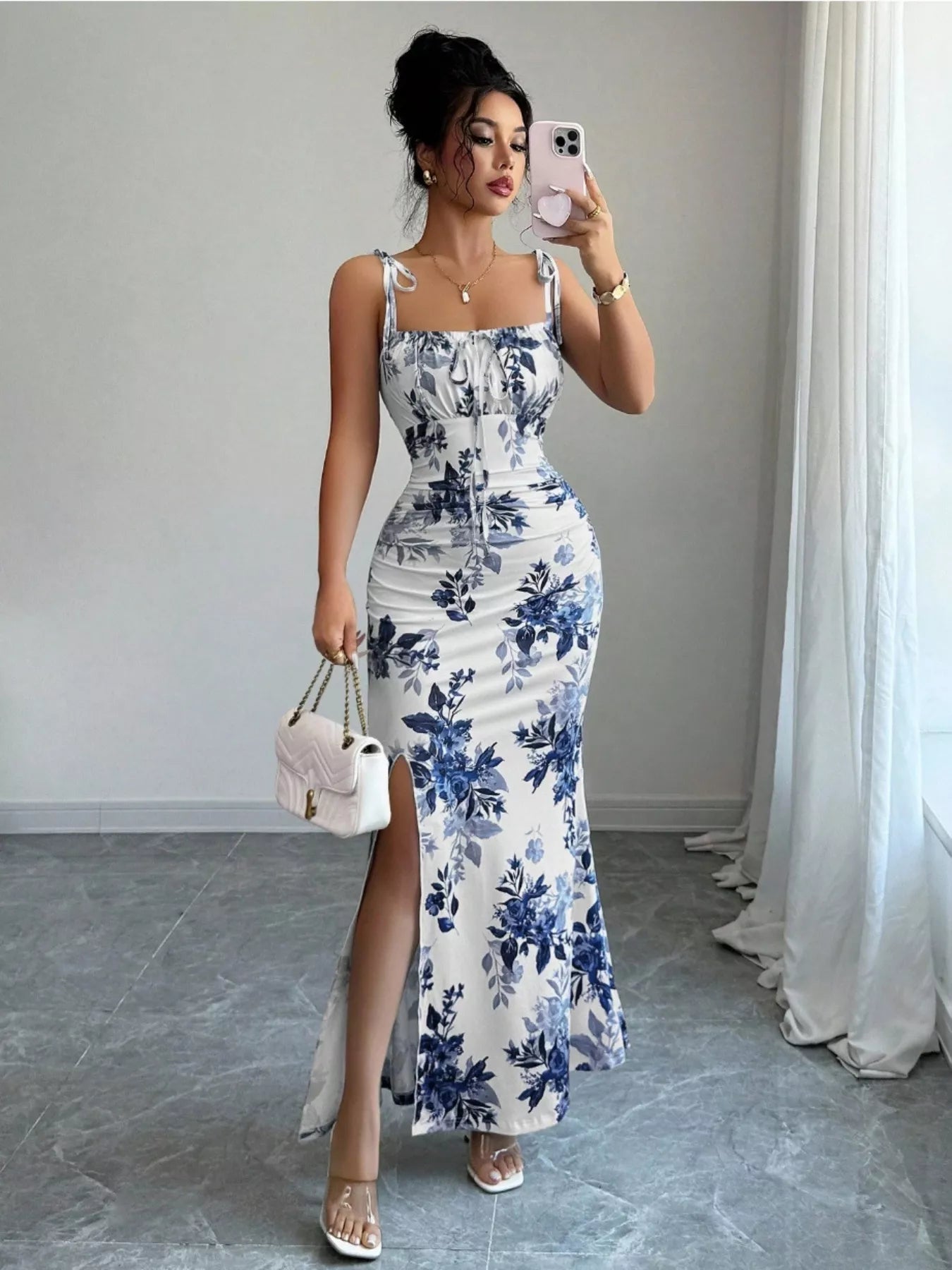 Printed tie strap slit maxi dress by Trendsi featuring a flowing silhouette, adjustable straps, and a stylish slit design.