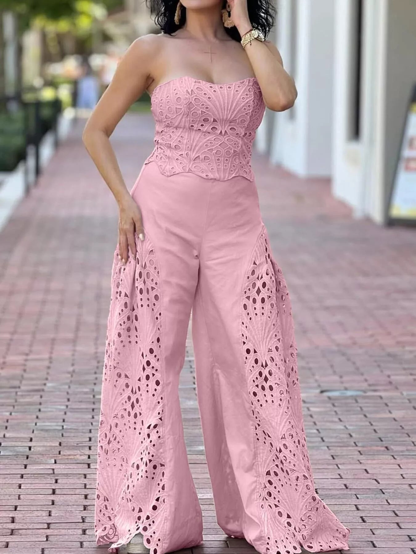Hollow-out tube top and pants set in black, trendy 2-piece fashion ensemble with cut-out details, styled by Trendsi.