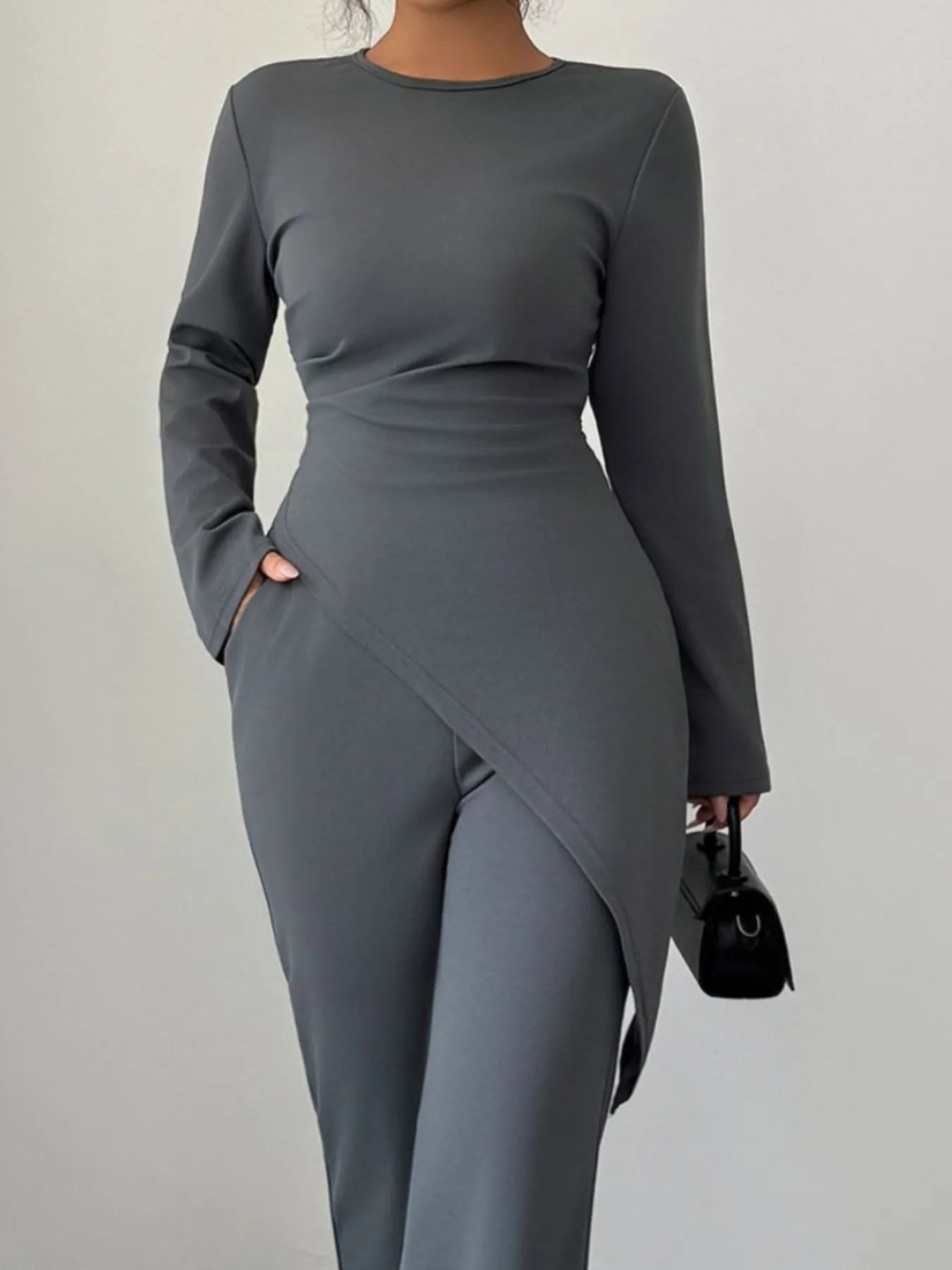 Asymmetric long sleeve top and matching pants set by Trendsi, featuring modern design and comfortable fit, shown in black.