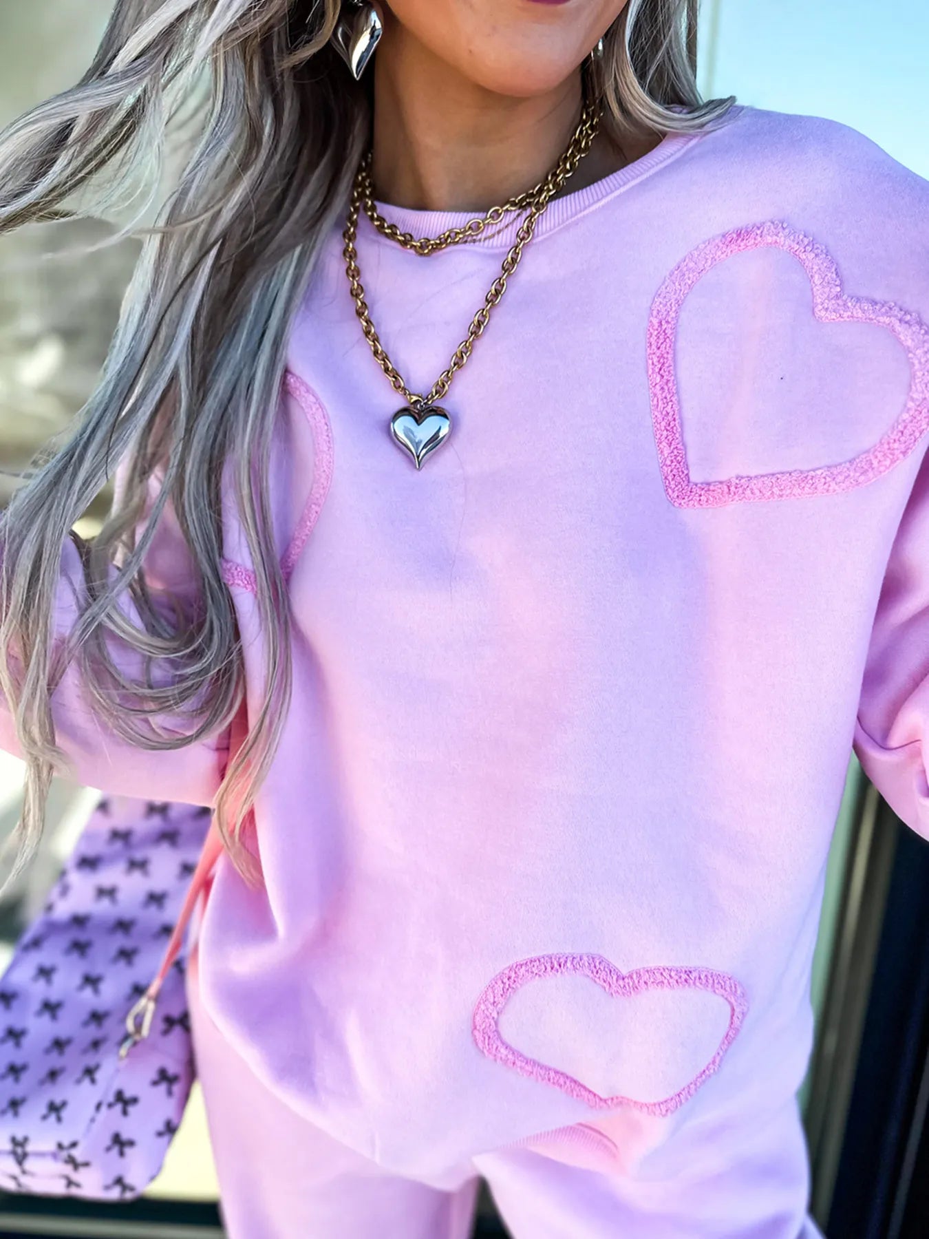 Trendsi round neck heart top and matching pants set, featuring a stylish heart design and comfortable fit.
