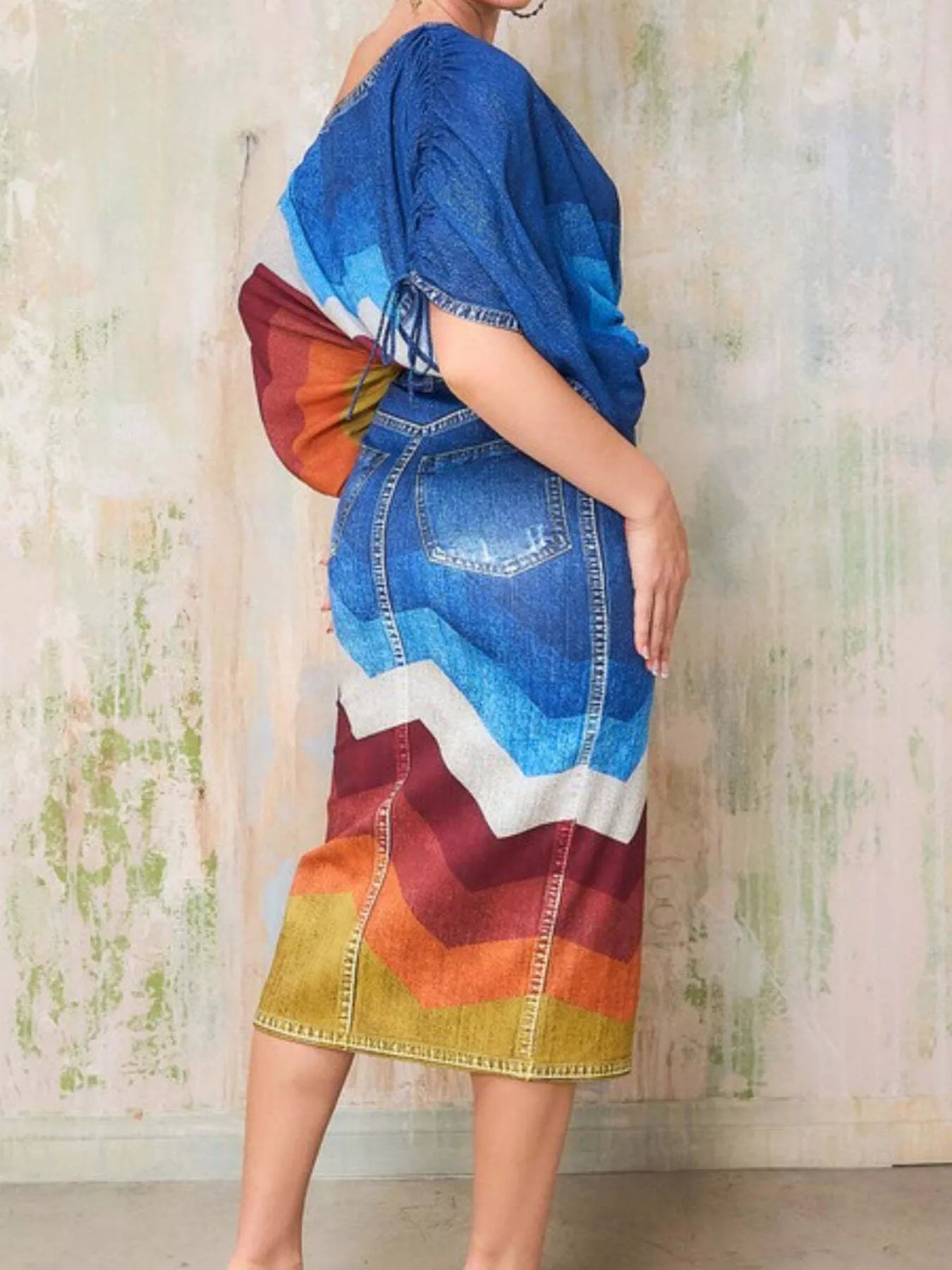 Blue one-shoulder top and slit skirt set by Trendsi, featuring a stylish design with a fitted top and flowing skirt.