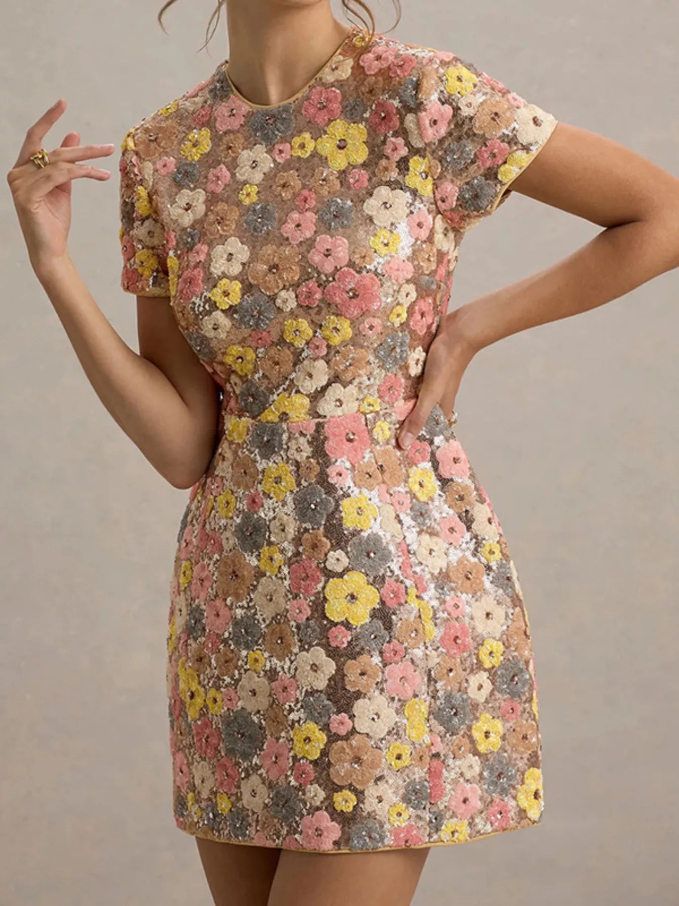 Floral sequin short sleeve mini dress by Trendsi, featuring a vibrant floral pattern and shimmering sequin details.
