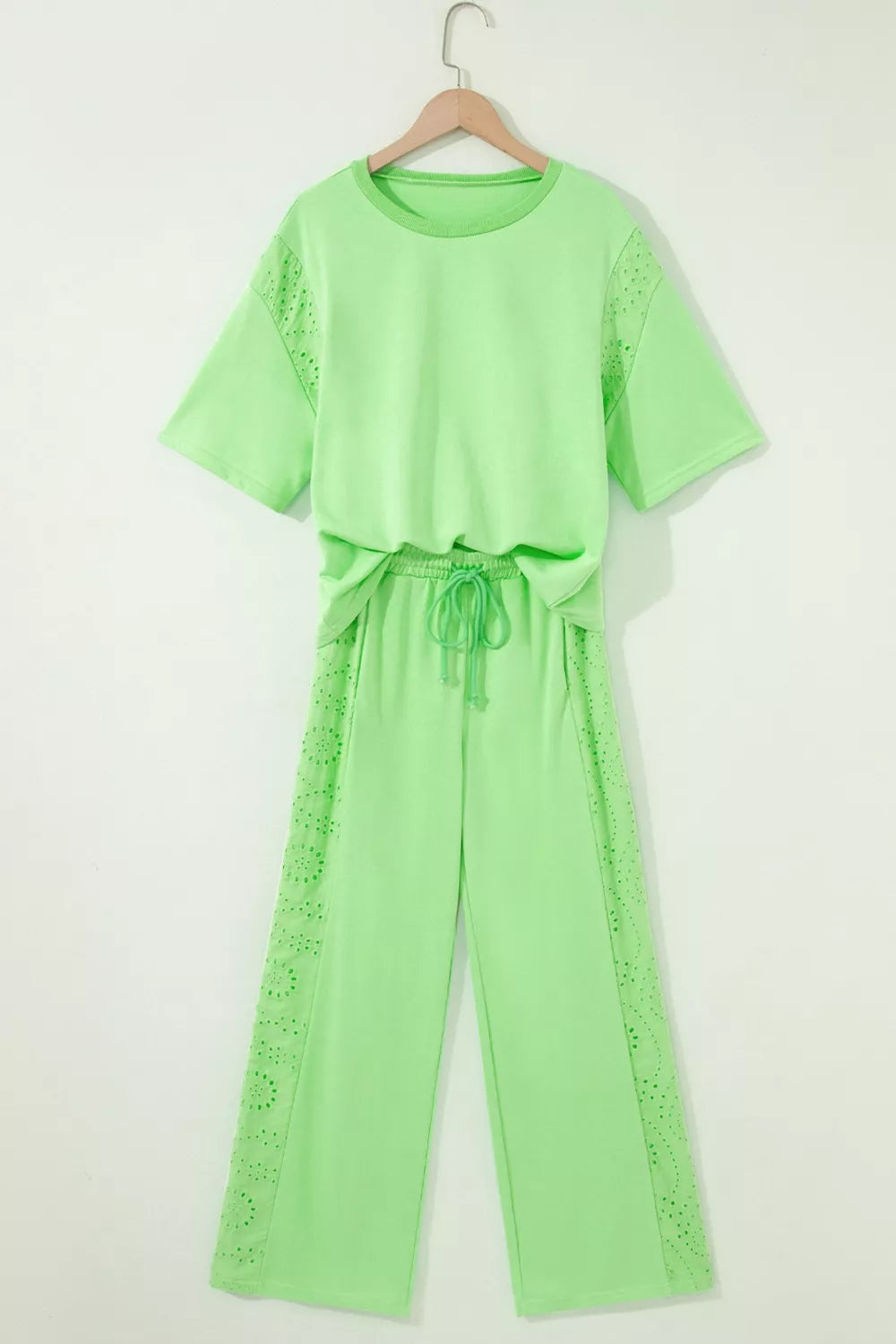 Lace patchwork half sleeve top and elastic waist pants two-piece loungewear set by Trendsi, shown on a model.
