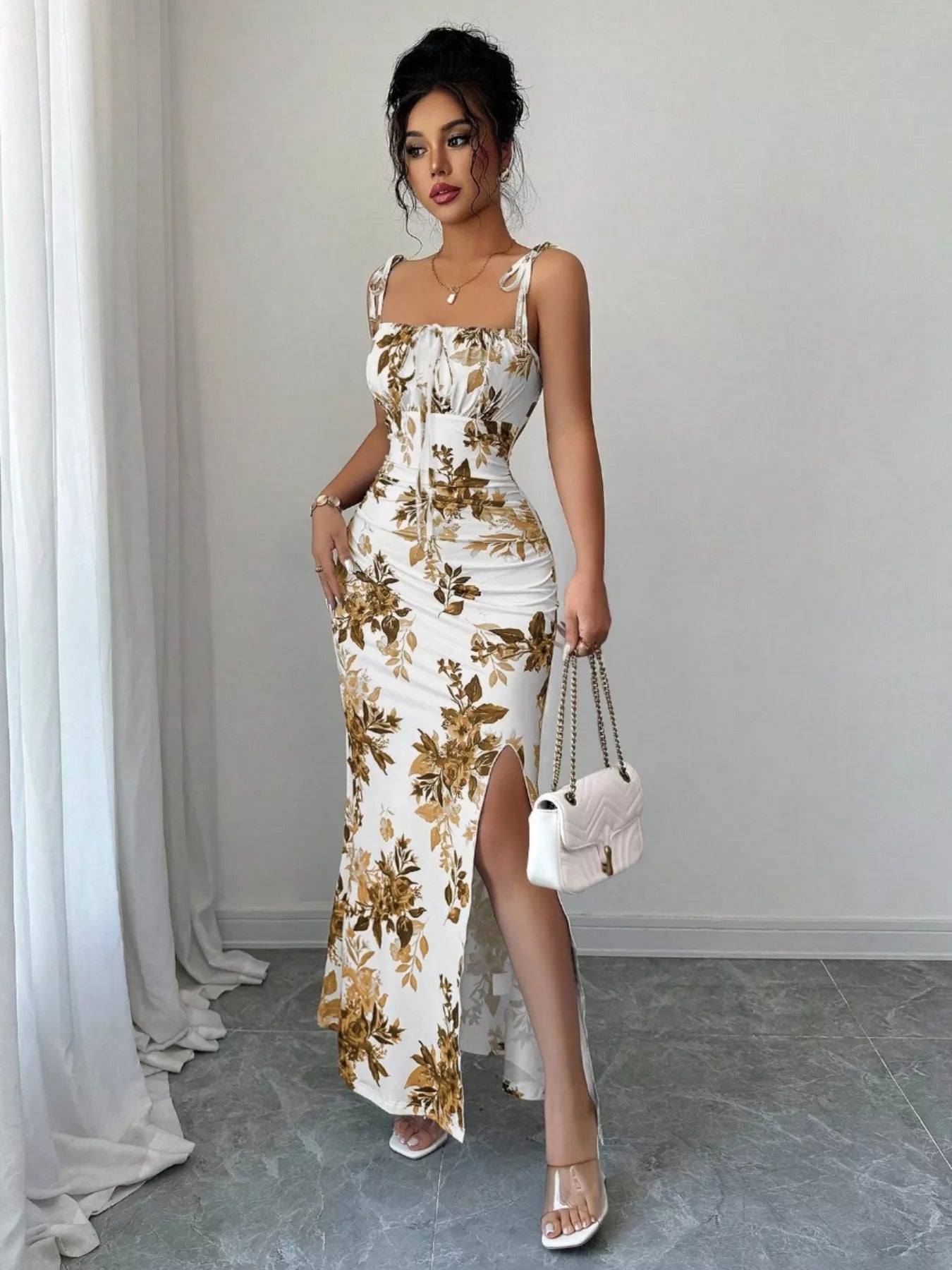 Printed tie-strap slit maxi dress by Trendsi featuring a flowy silhouette, slit detail, and adjustable tie straps.