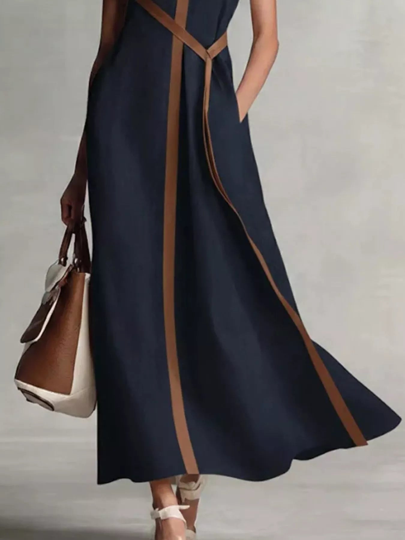 Sleeveless maxi dress with contrast trim from Trendsi, featuring a flowing silhouette and stylish design.