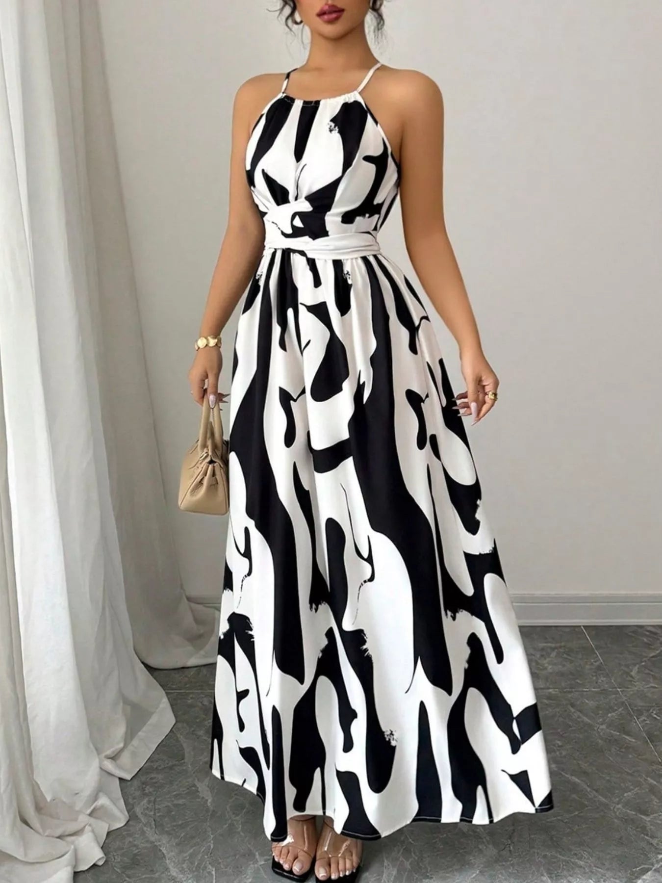Abstract print halter neck maxi dress from Trendsi featuring a flowing silhouette and bold, colorful pattern.