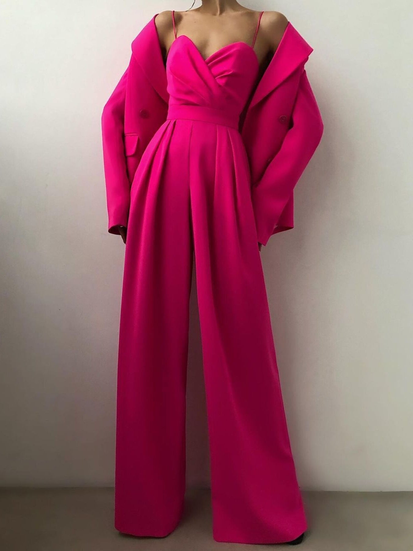 Trendsi spaghetti strap wide leg jumpsuit with flowing fabric, sleeveless design, and casual chic style.