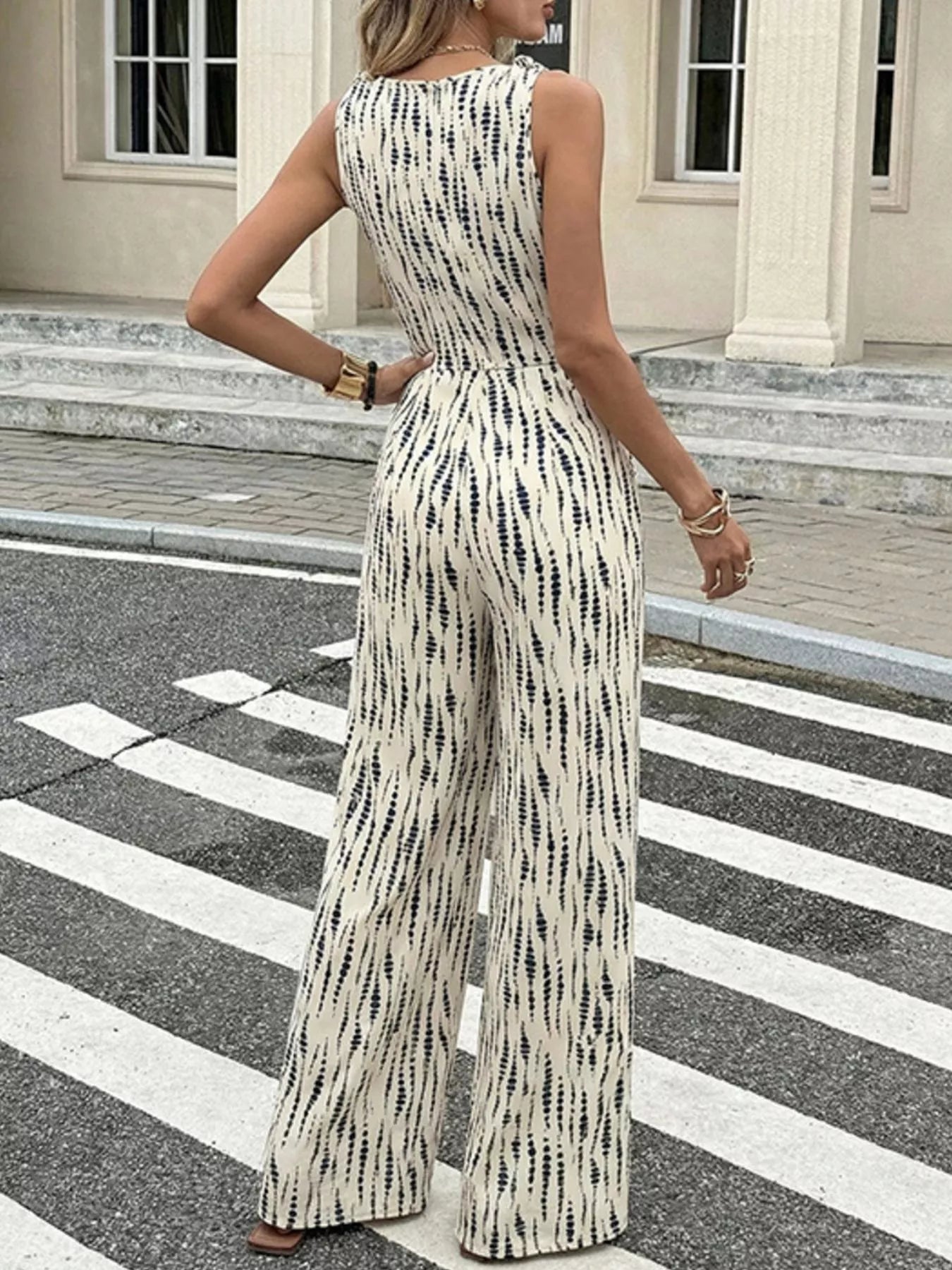 Printed wide leg jumpsuit by Trendsi featuring a relaxed fit, bold floral pattern, and wide-leg silhouette in lightweight fabric.