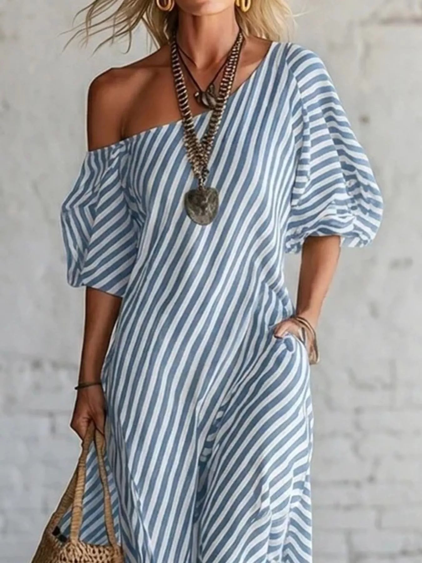 Striped one-shoulder maxi dress from Trendsi featuring a flowing silhouette and bold vertical stripes.